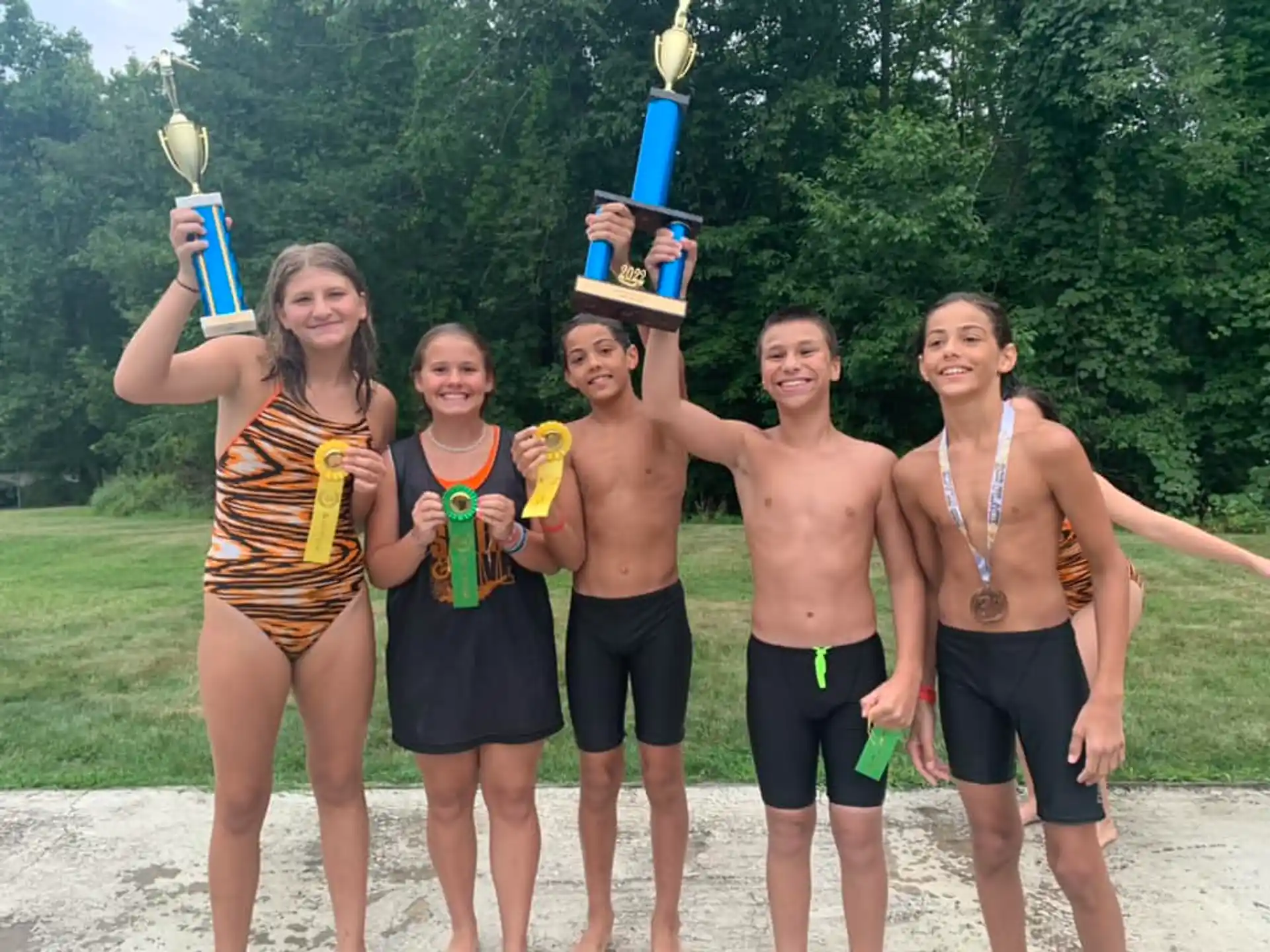 a group of people holding trophies