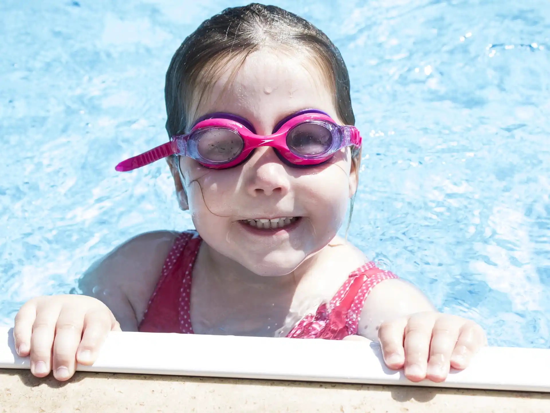 a baby wearing pink goggles