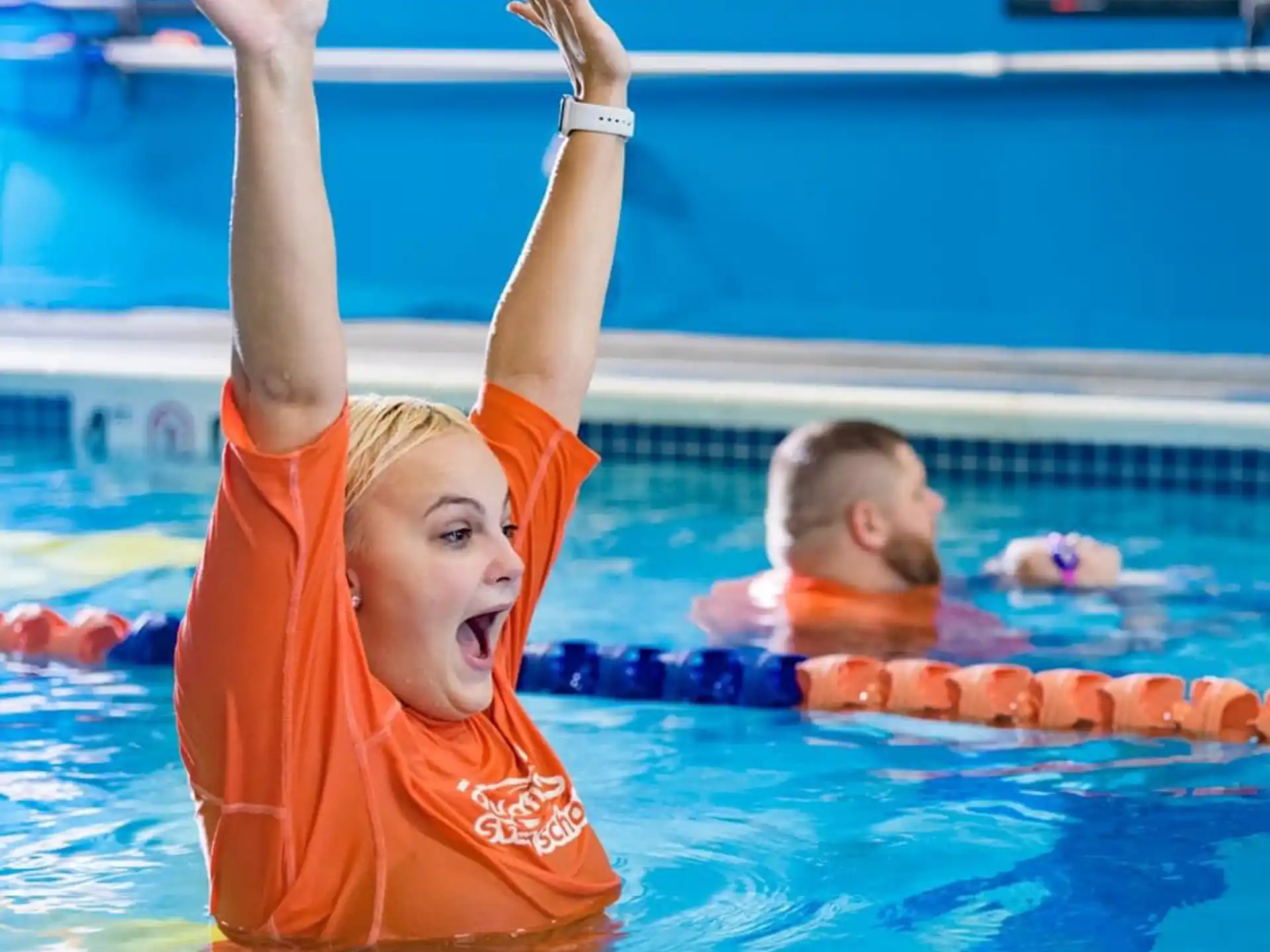 a couple of kids in a pool