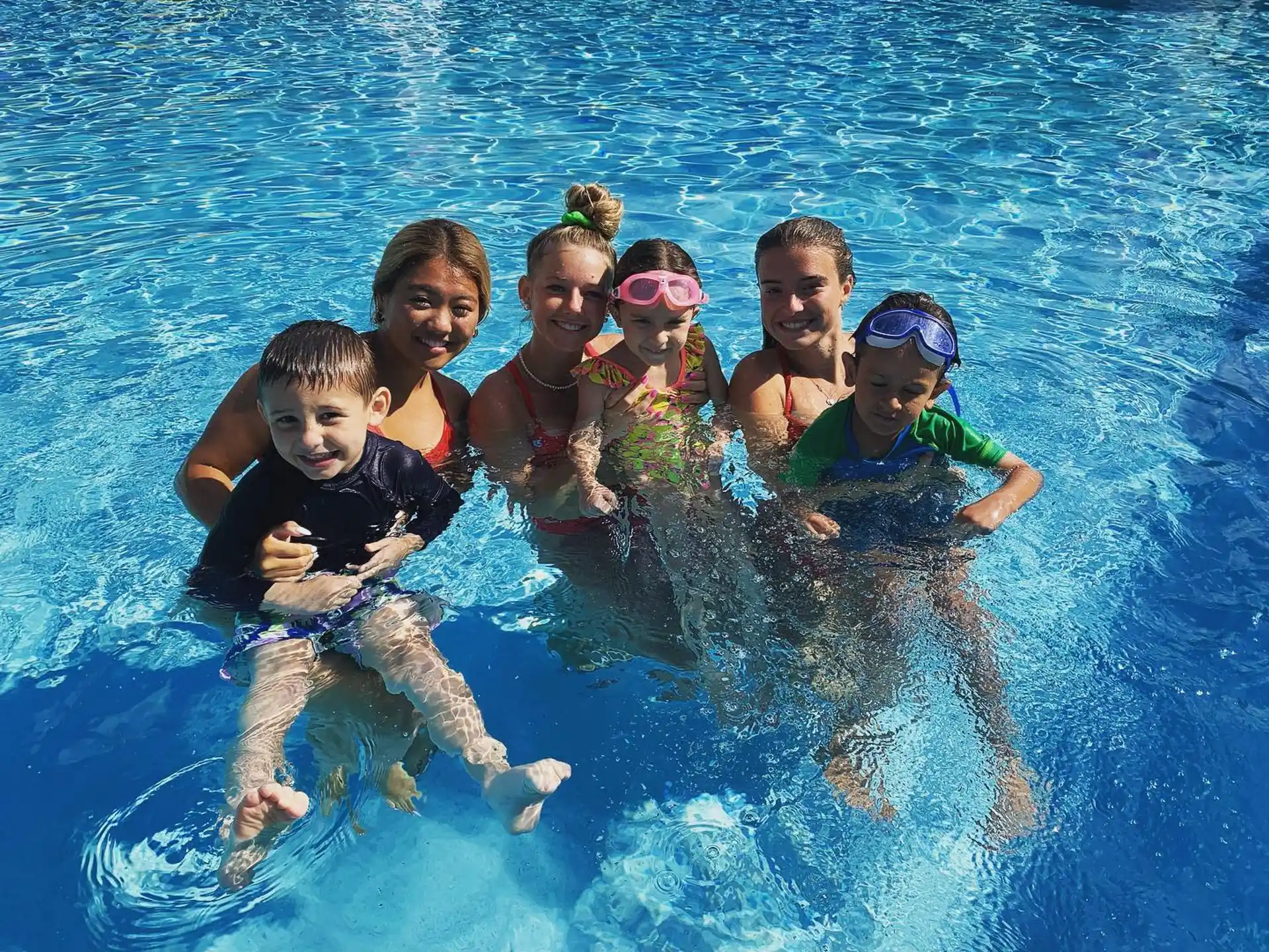 a group of kids in a pool
