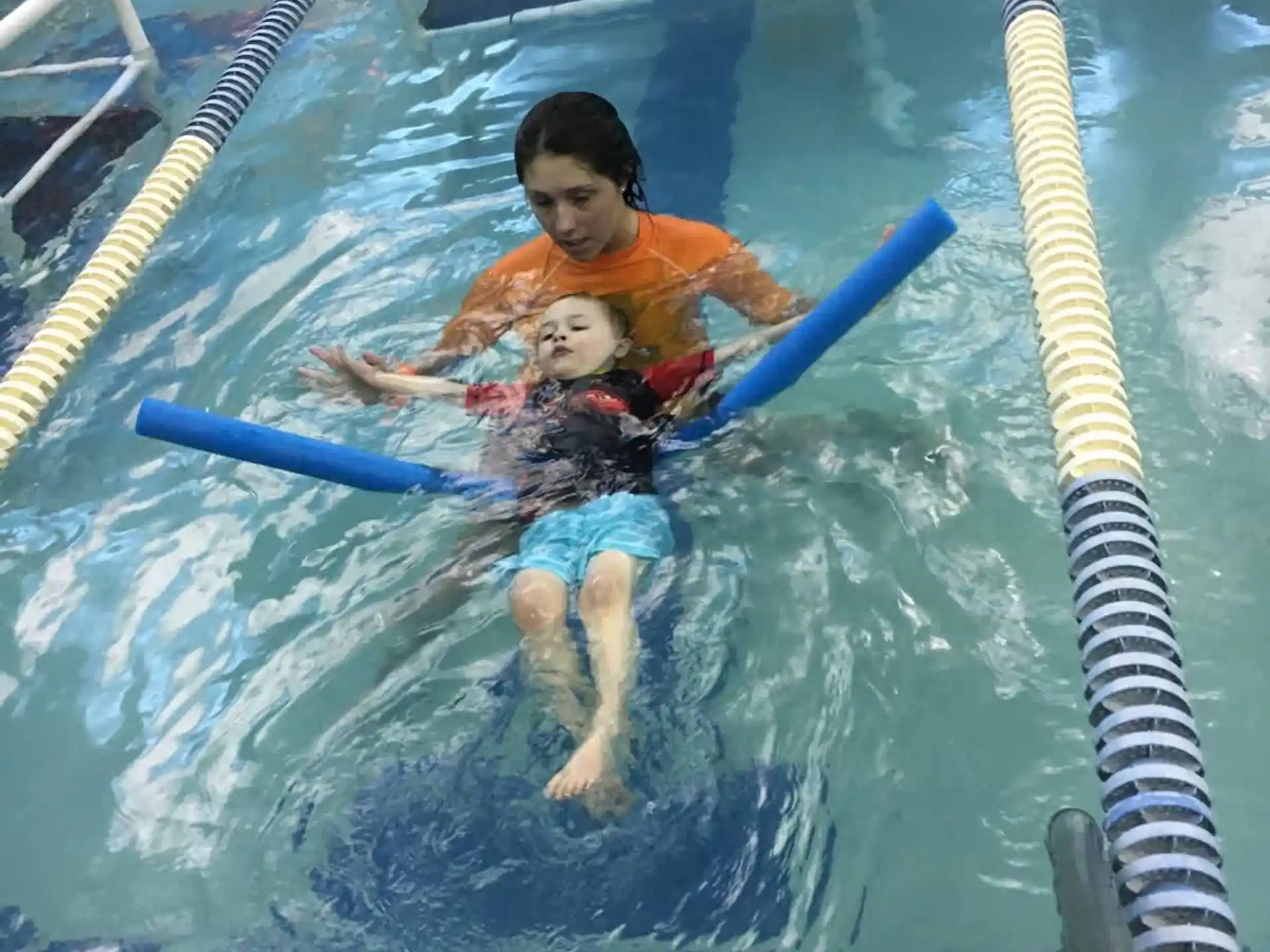 a man and a baby in a pool