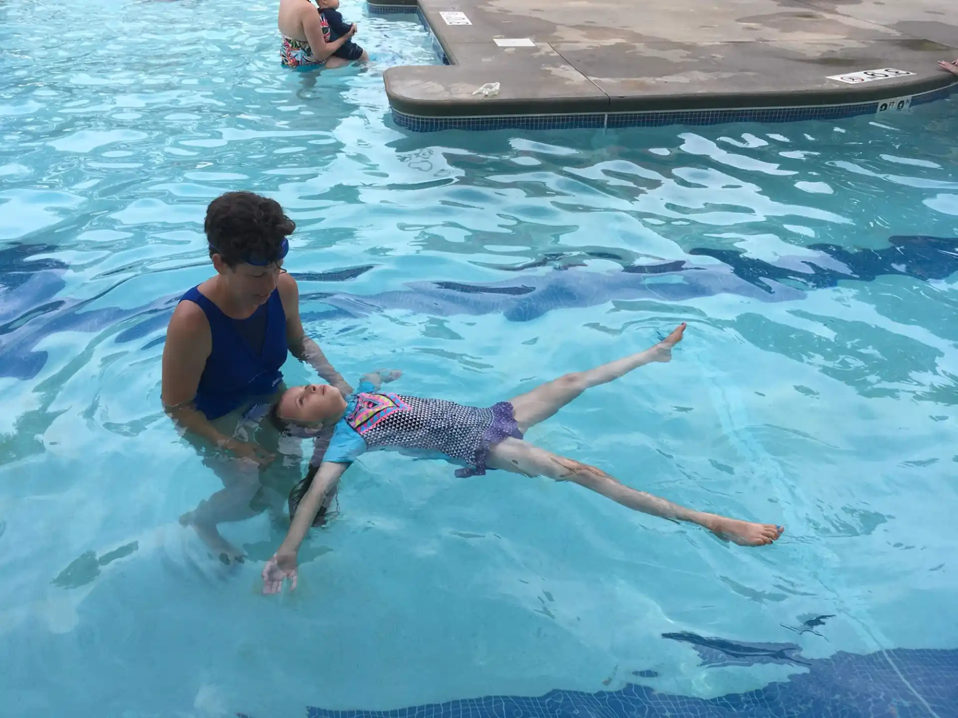 a man and a child in a pool