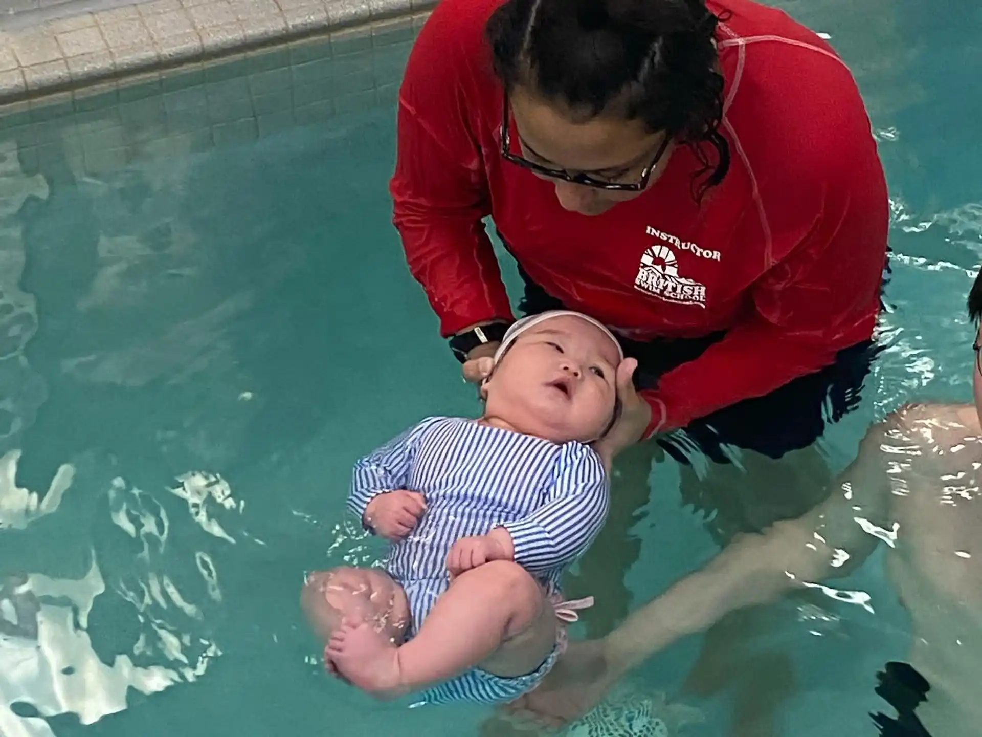 a person and a baby in a pool