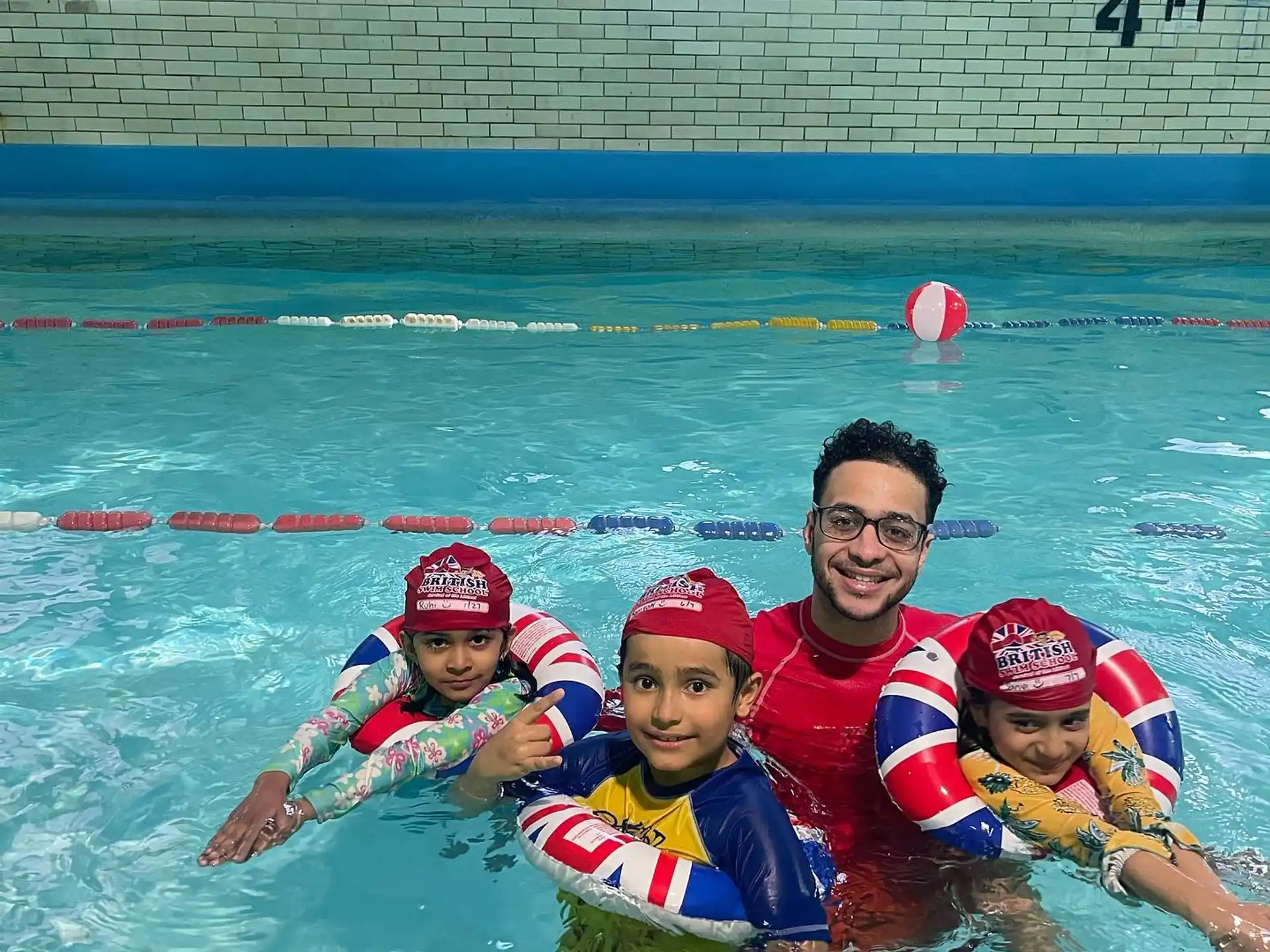 a person and two children in a pool