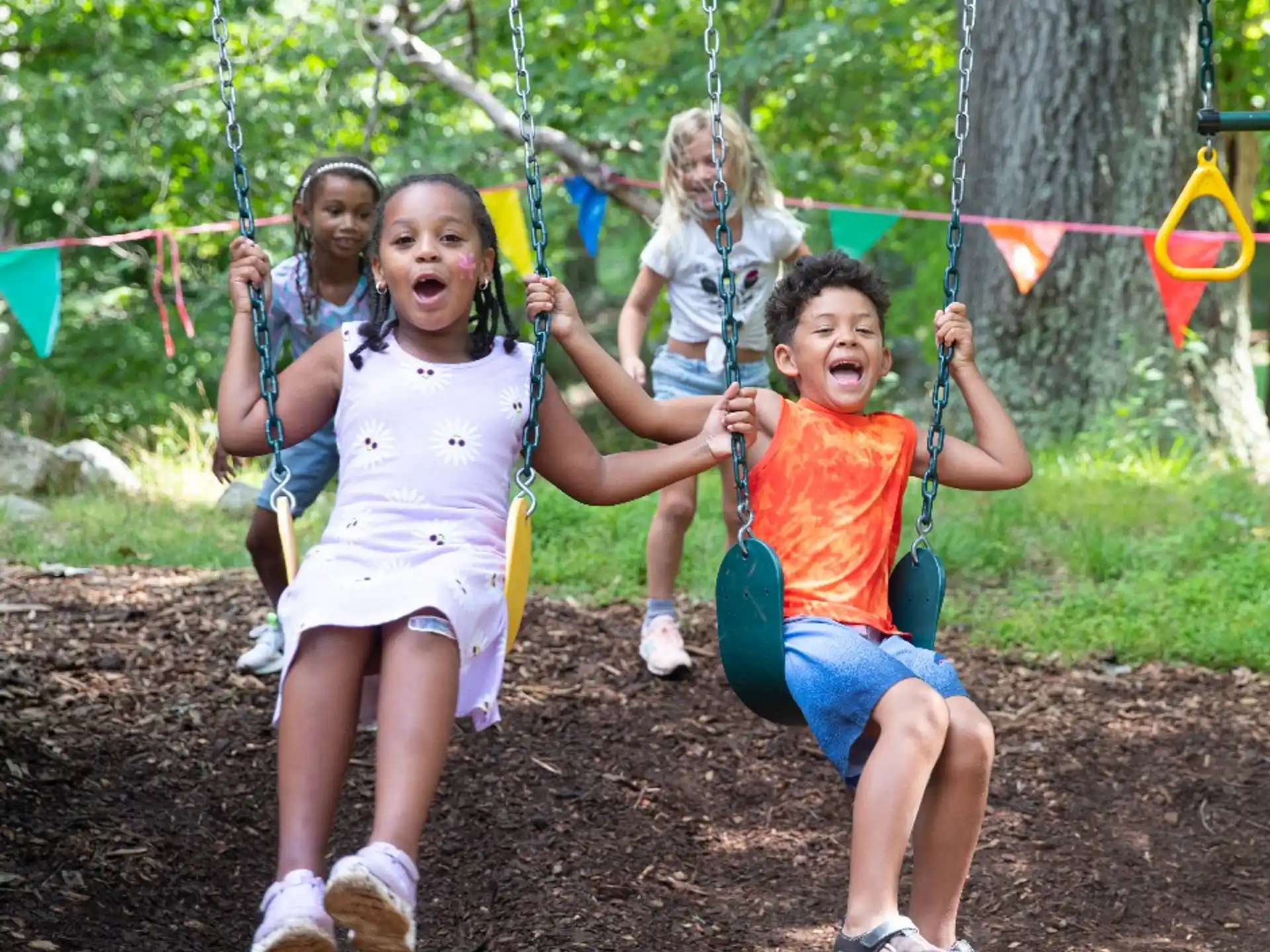 a group of children on swings