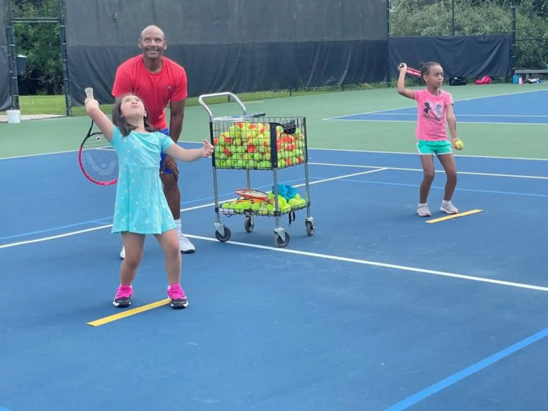 a couple of girls playing tennis