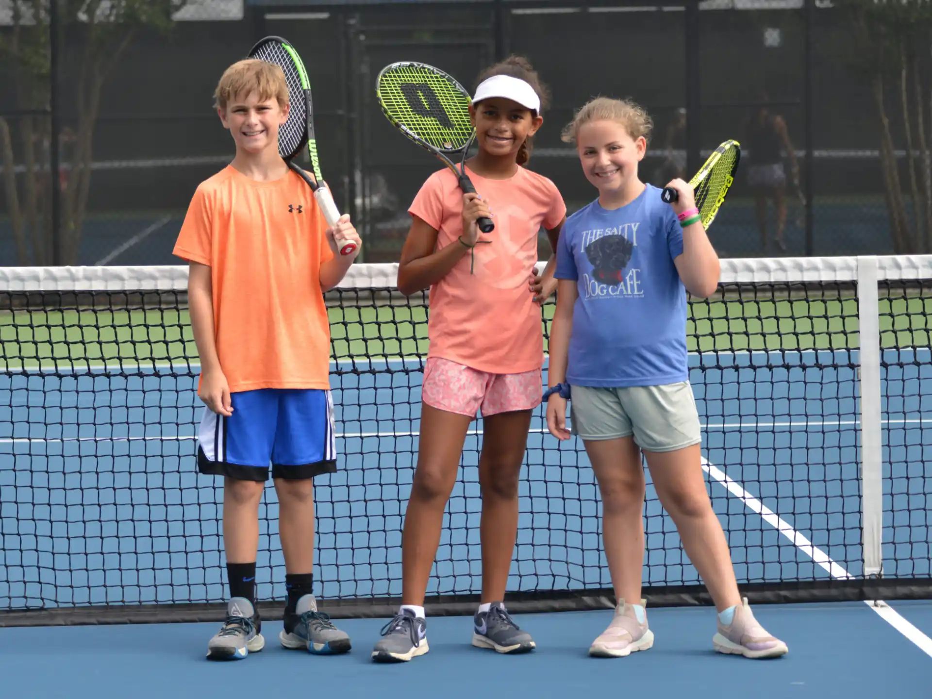 kids holding tennis rackets