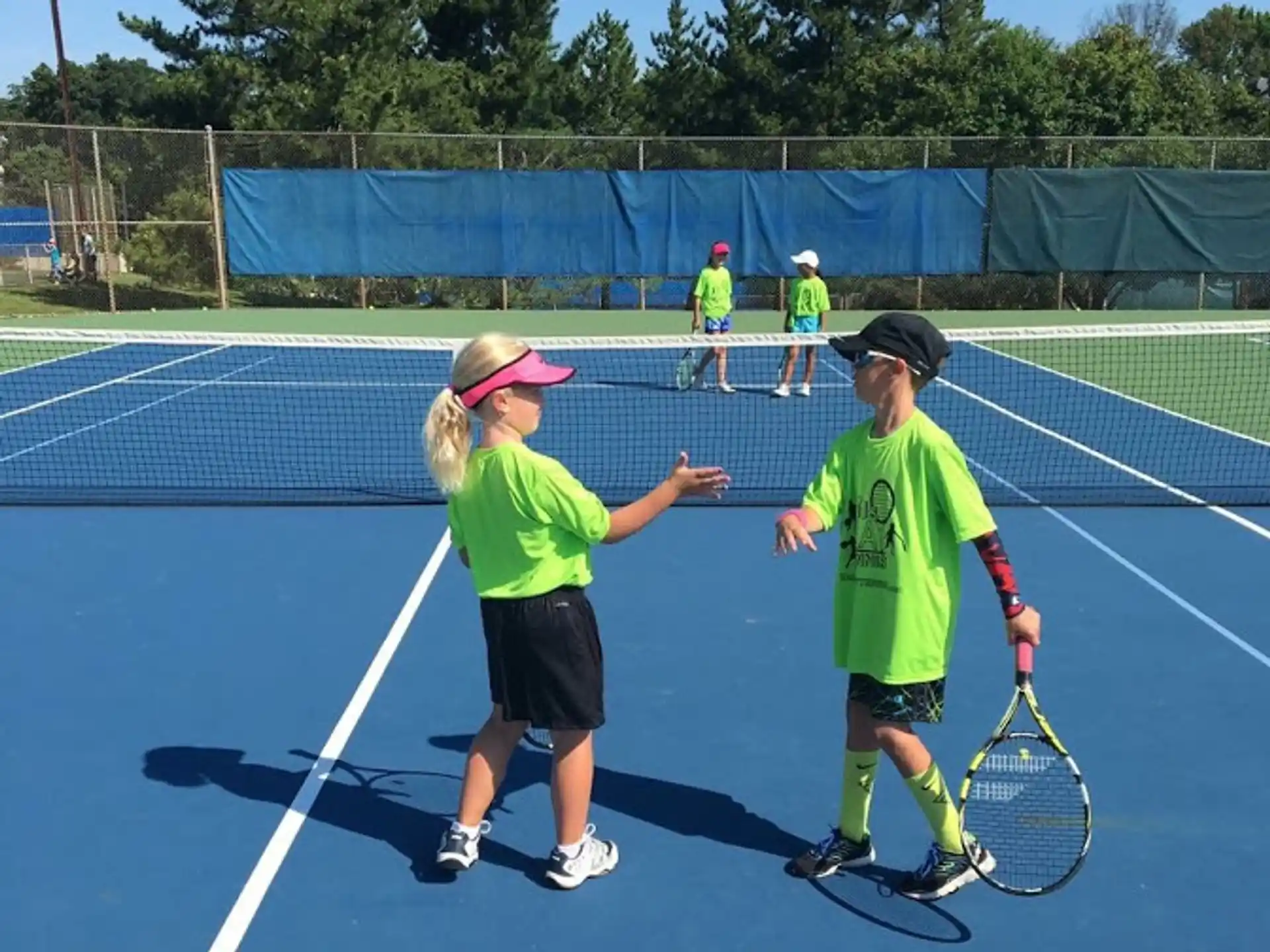 kids playing tennis on a court