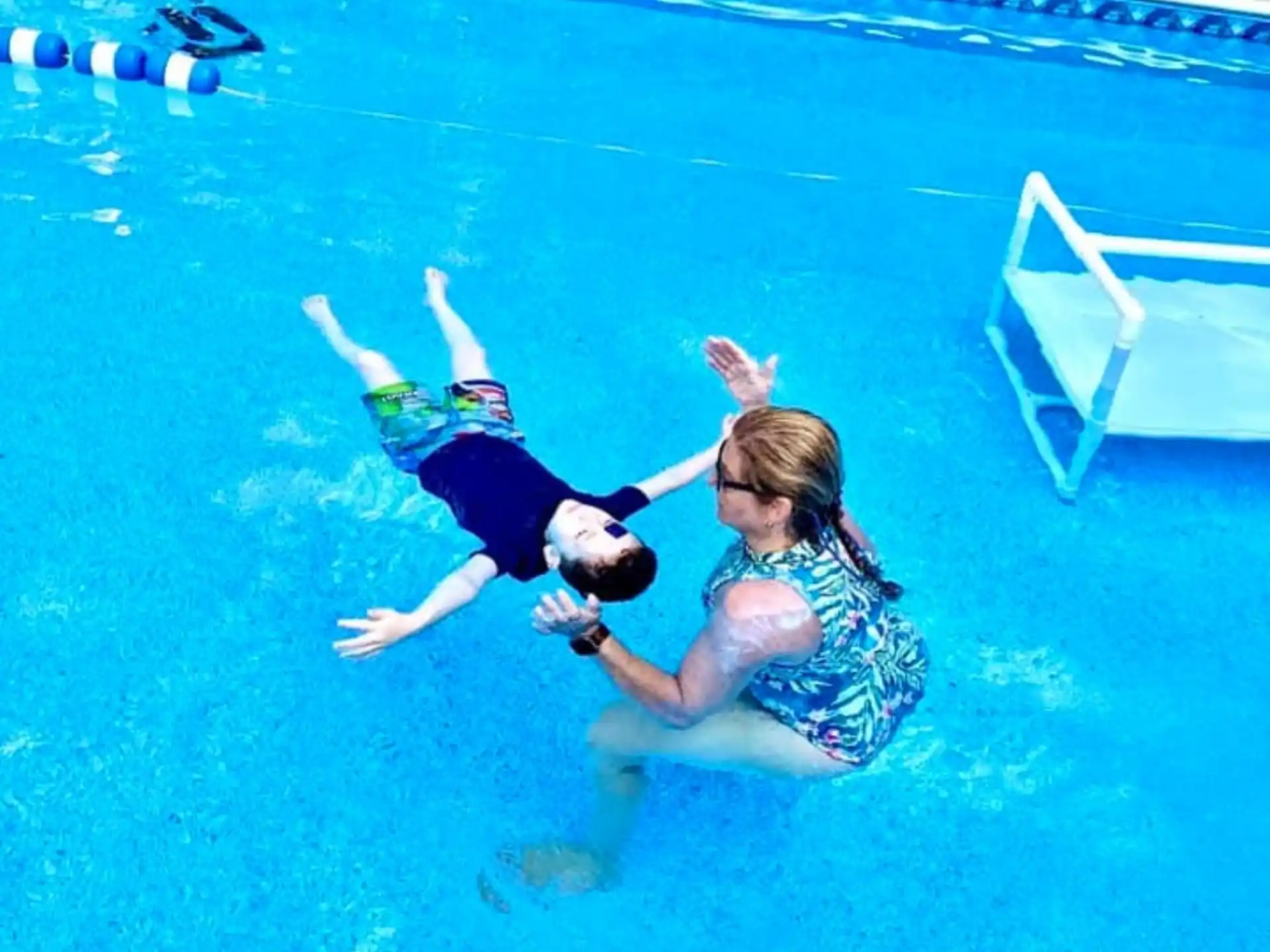 a man and woman in a swimming pool