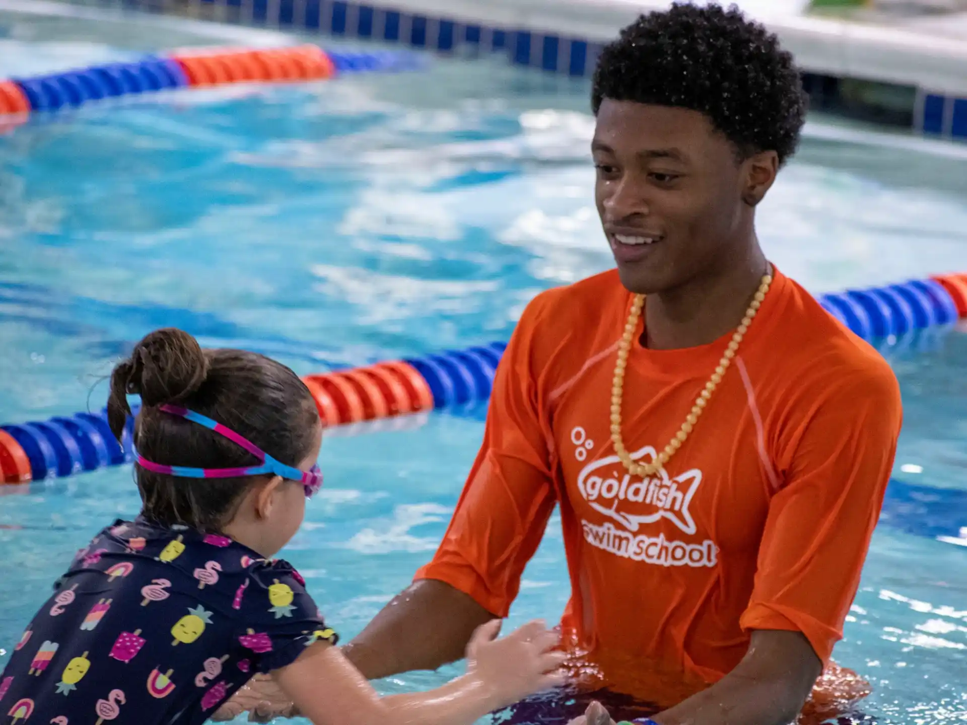 a man and a girl in a pool