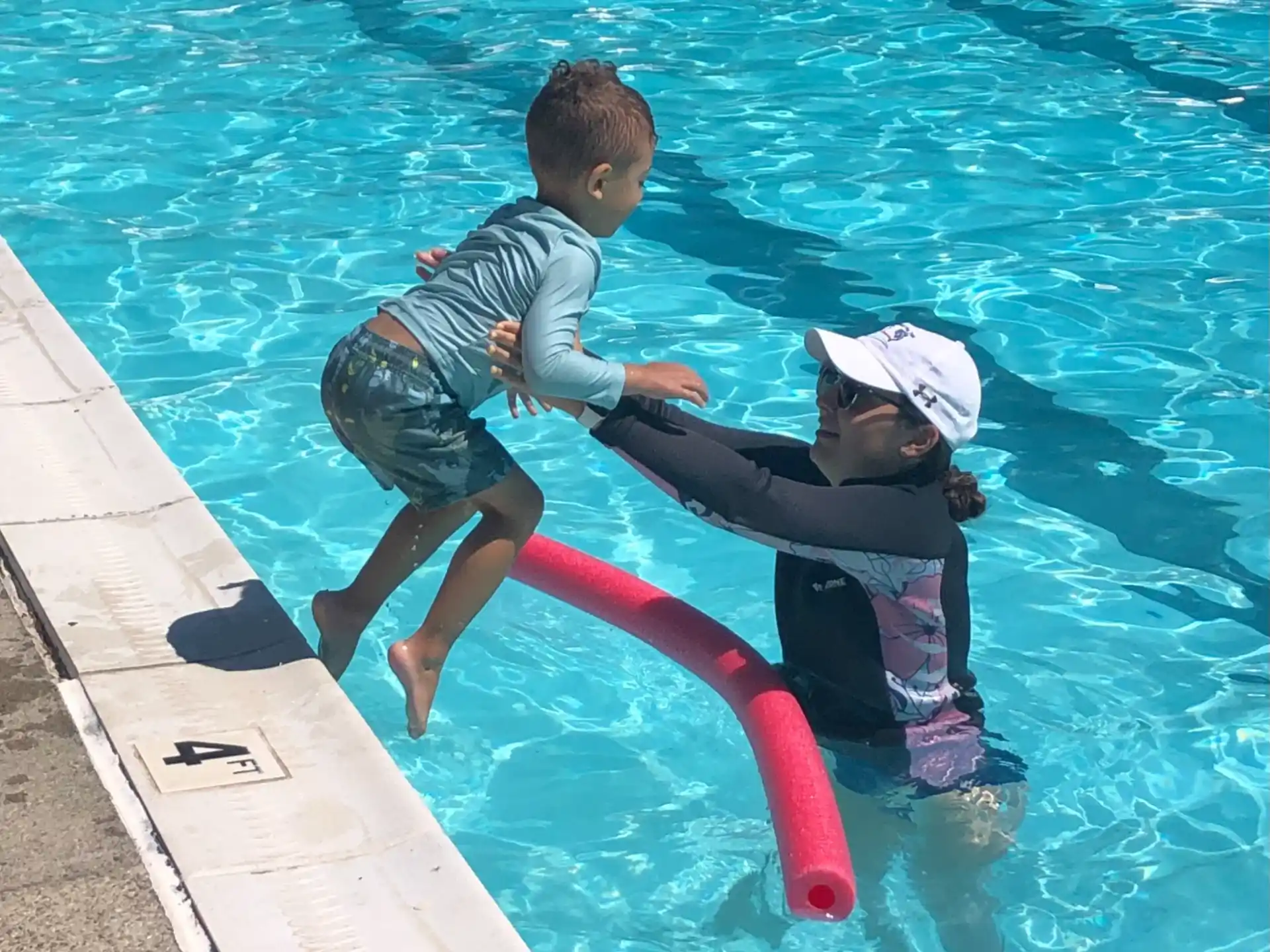 a couple of kids playing in a pool