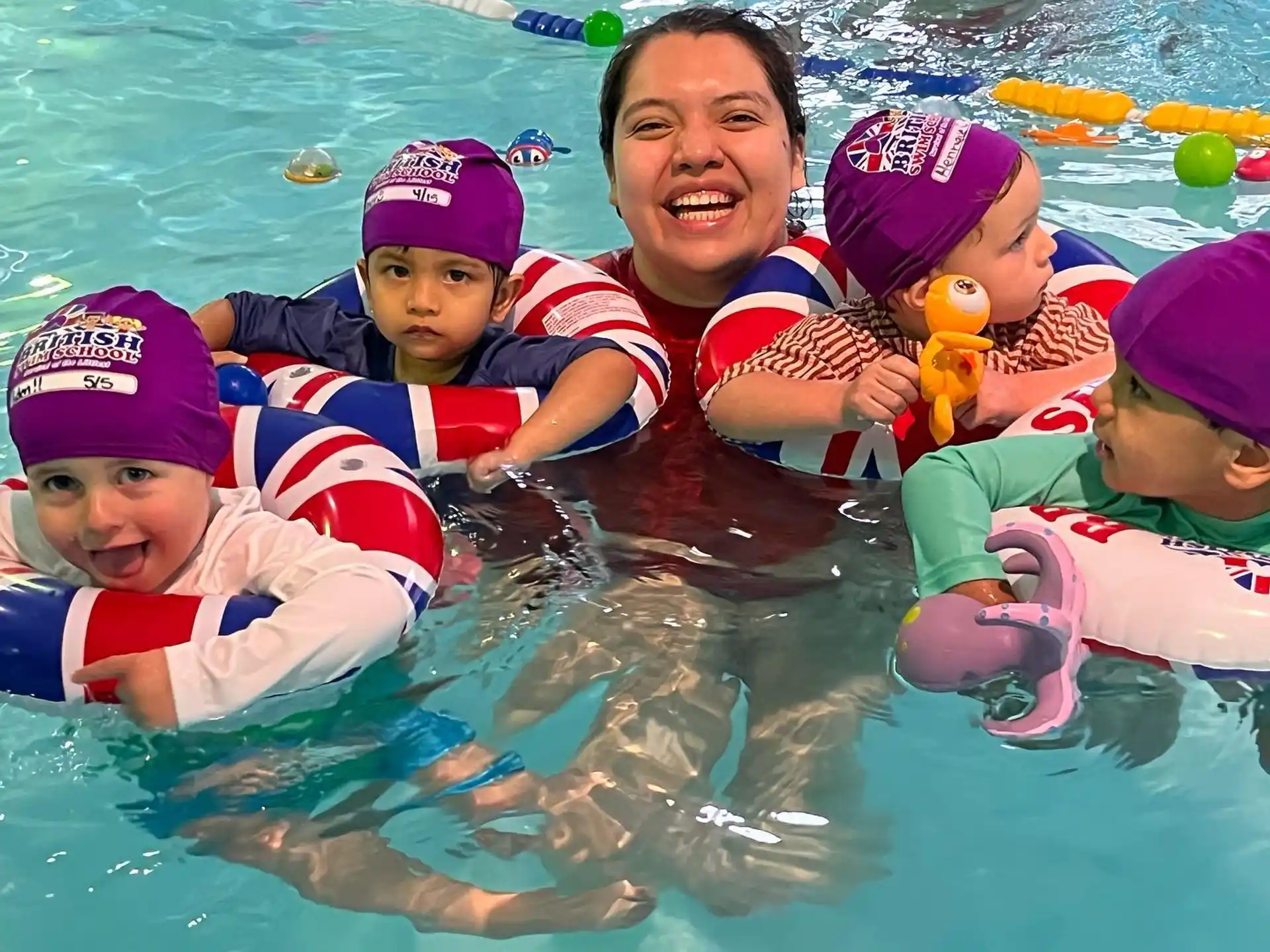 a person and several children in a pool
