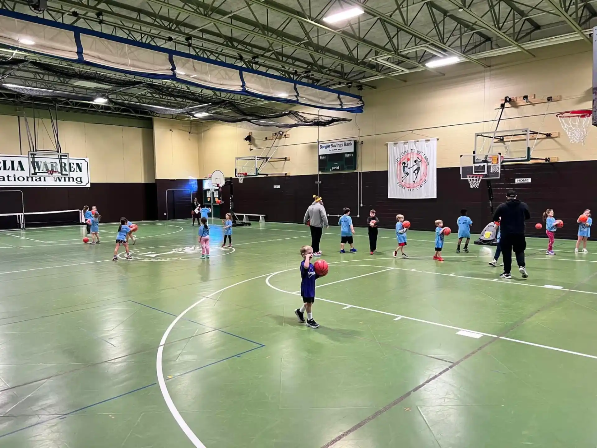 a group of people playing basketball