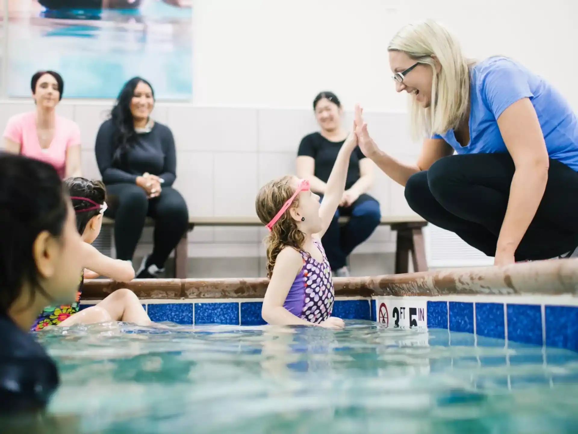 a group of people sitting around a pool