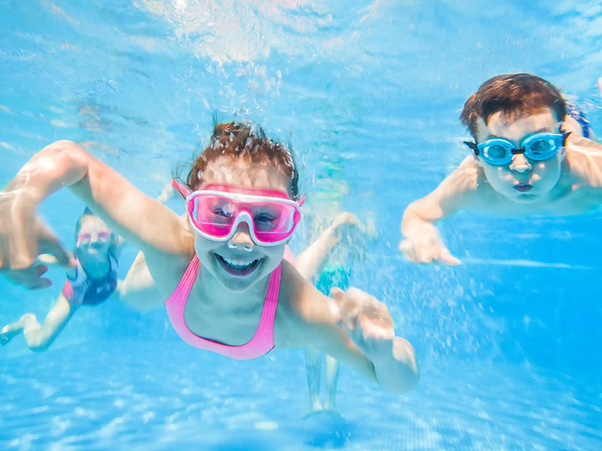 a couple of kids swimming in a pool