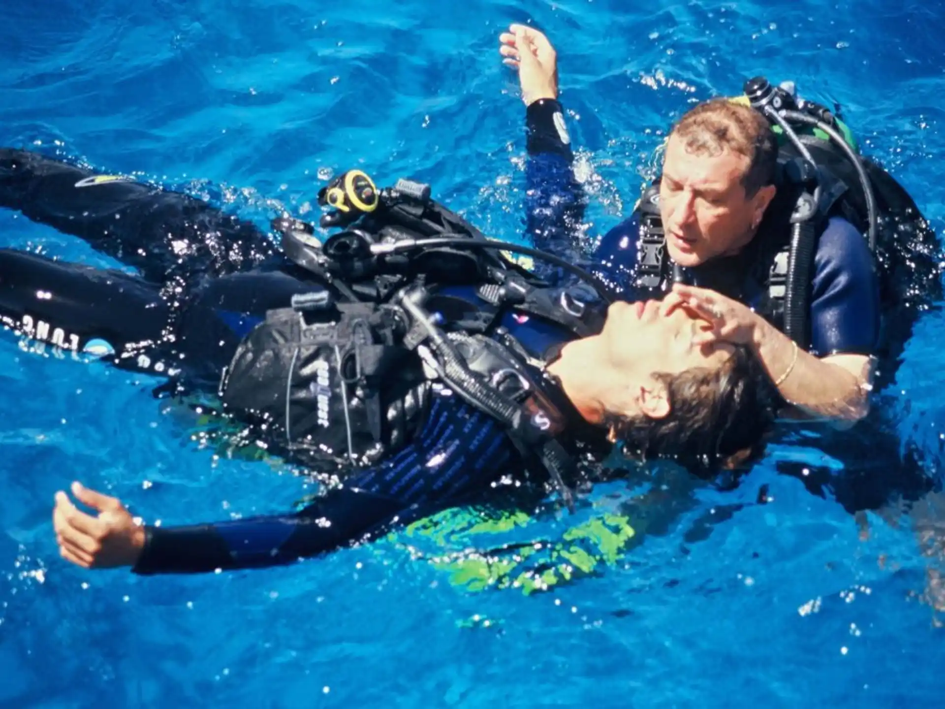 a man and a woman in scuba gear underwater