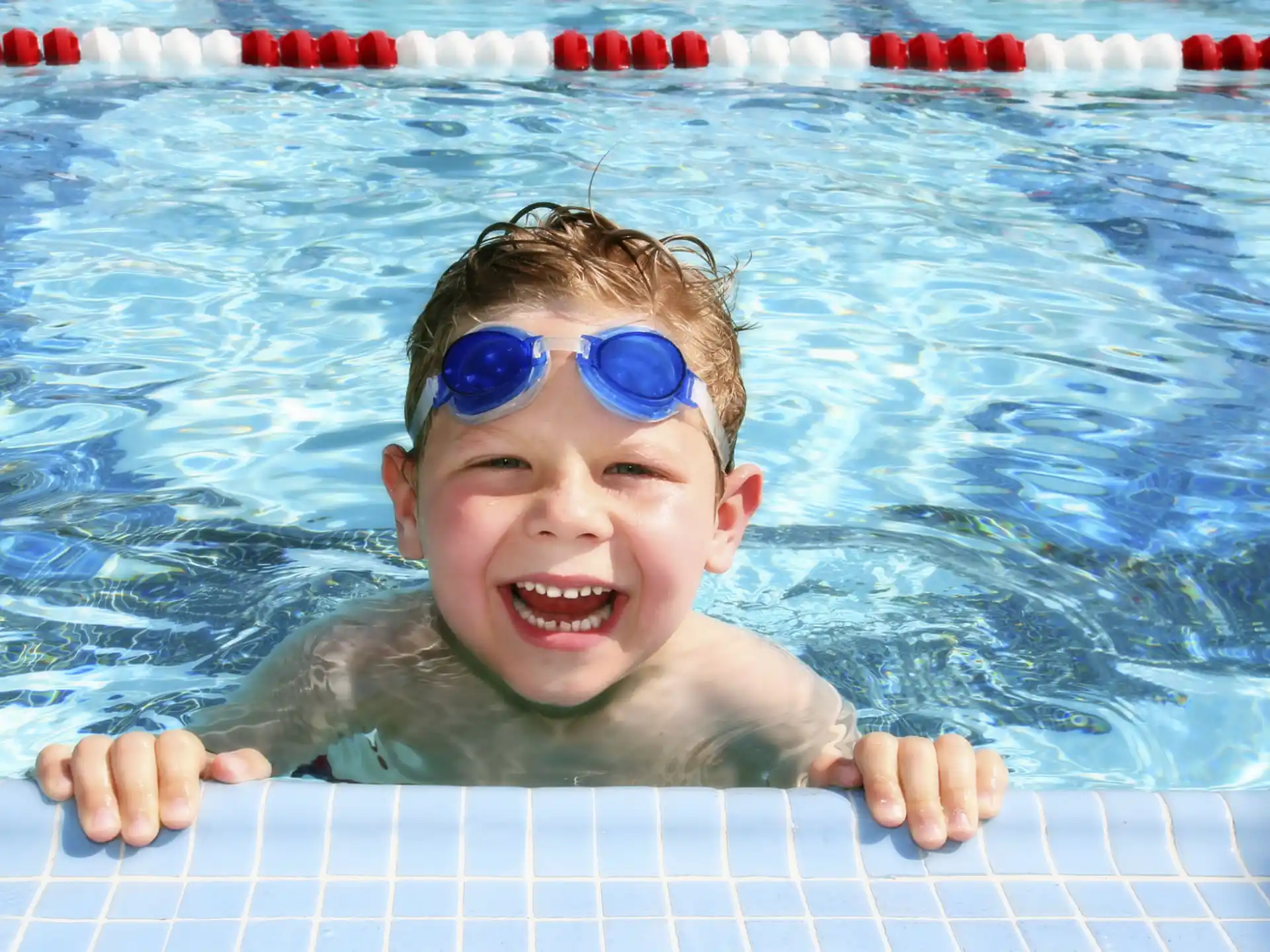a baby in a pool wearing goggles