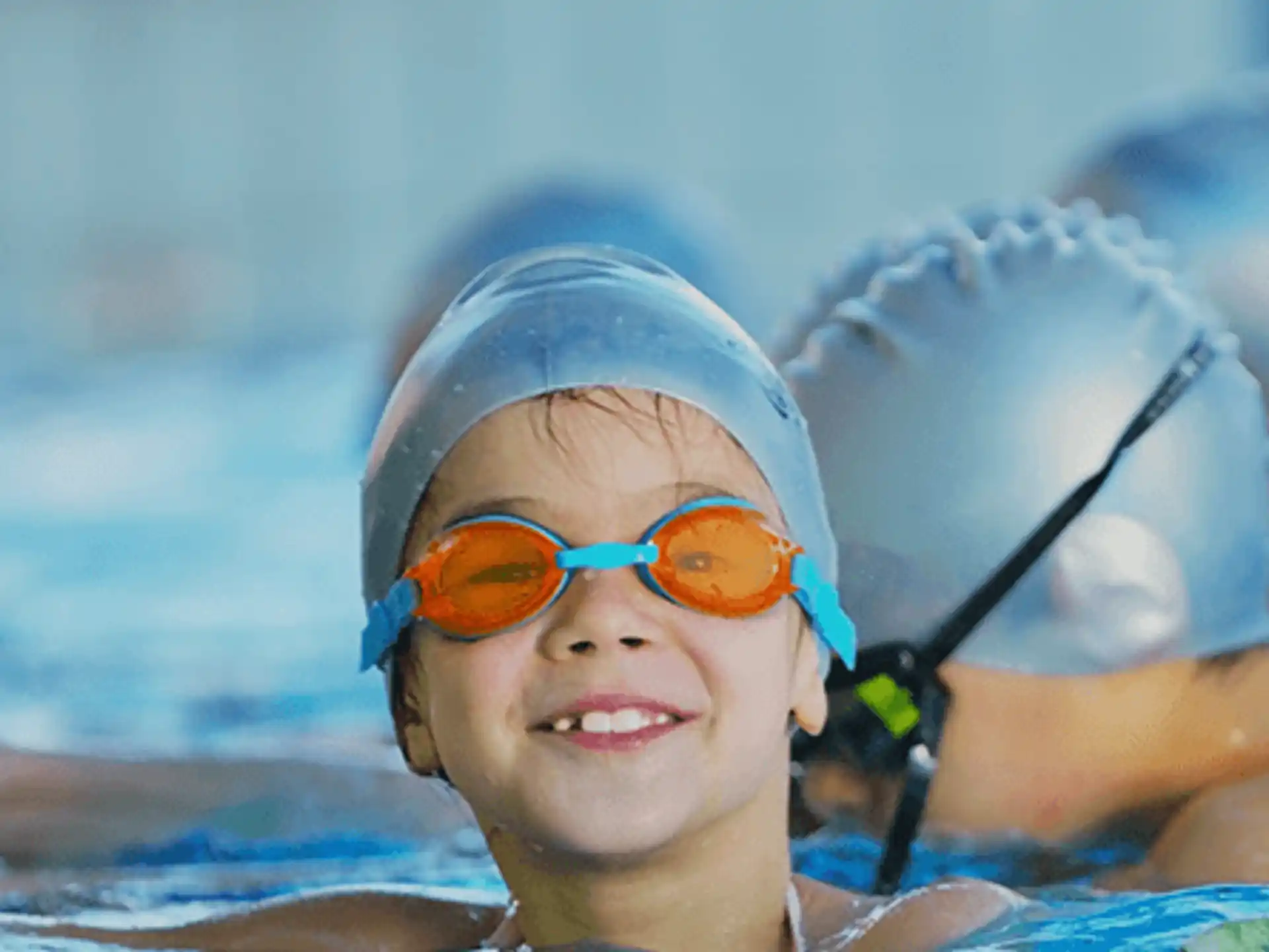 a child in a pool wearing goggles