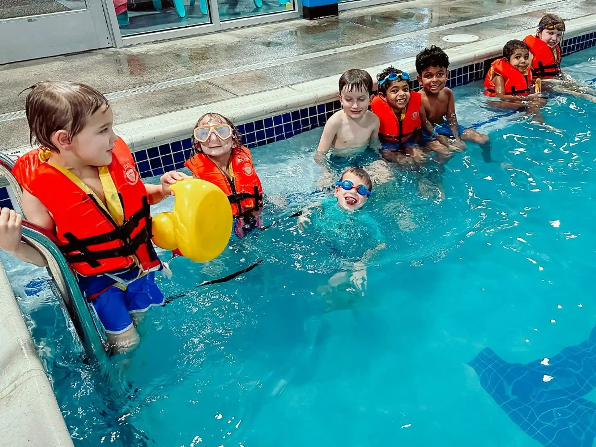 a group of kids in a pool