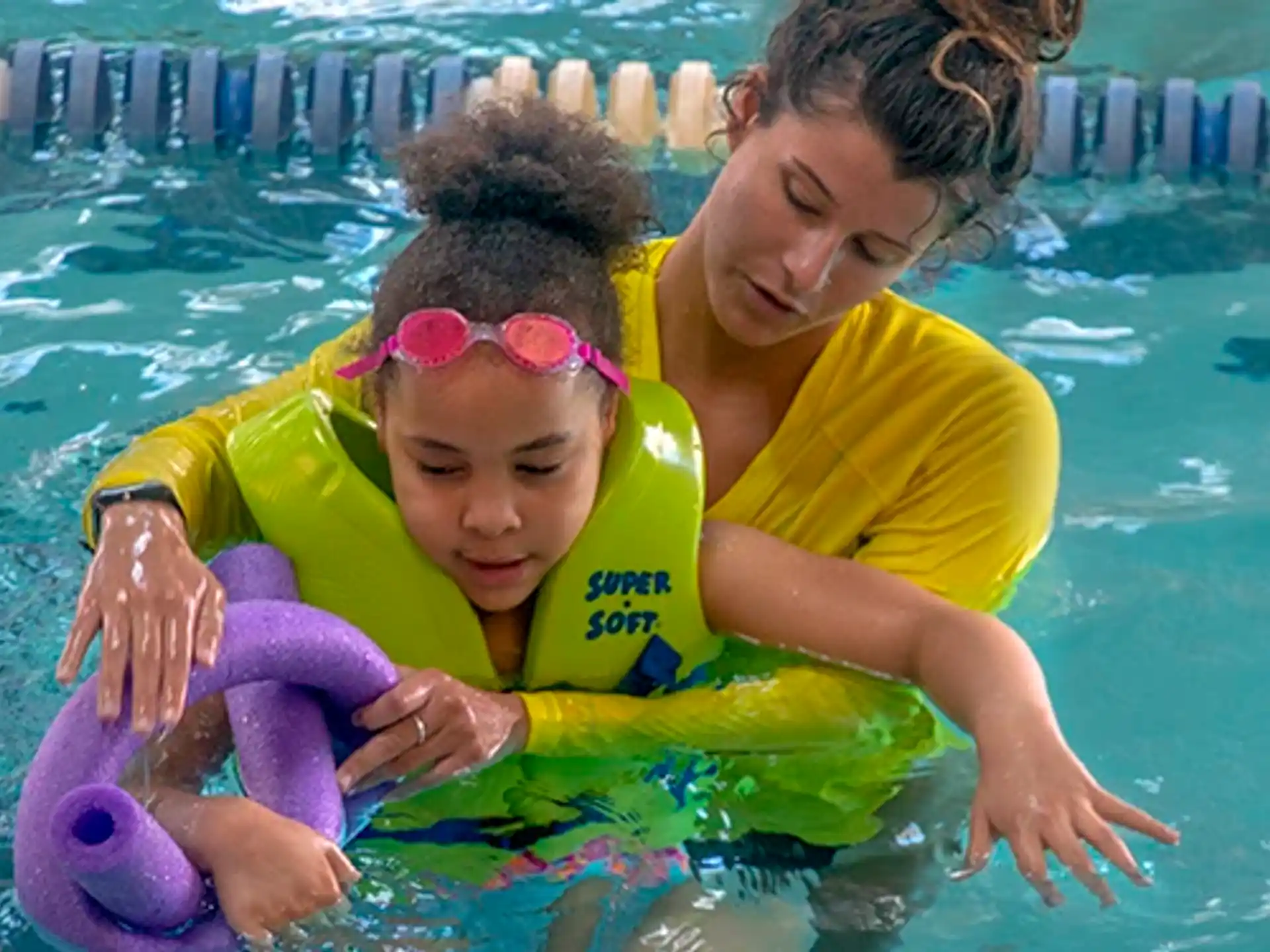 a person and a child in a pool