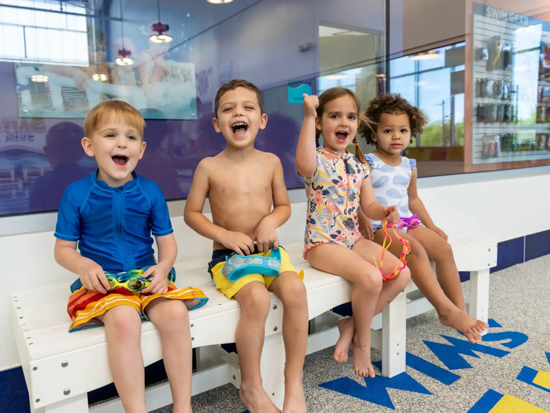 a group of kids sitting on a bench
