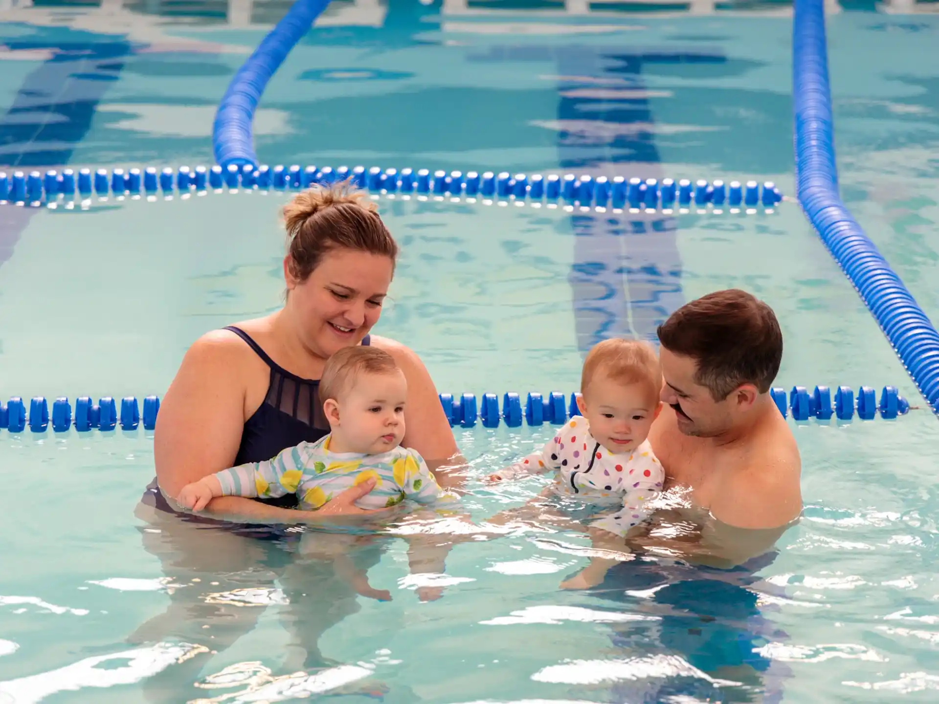 a person and two children in a pool