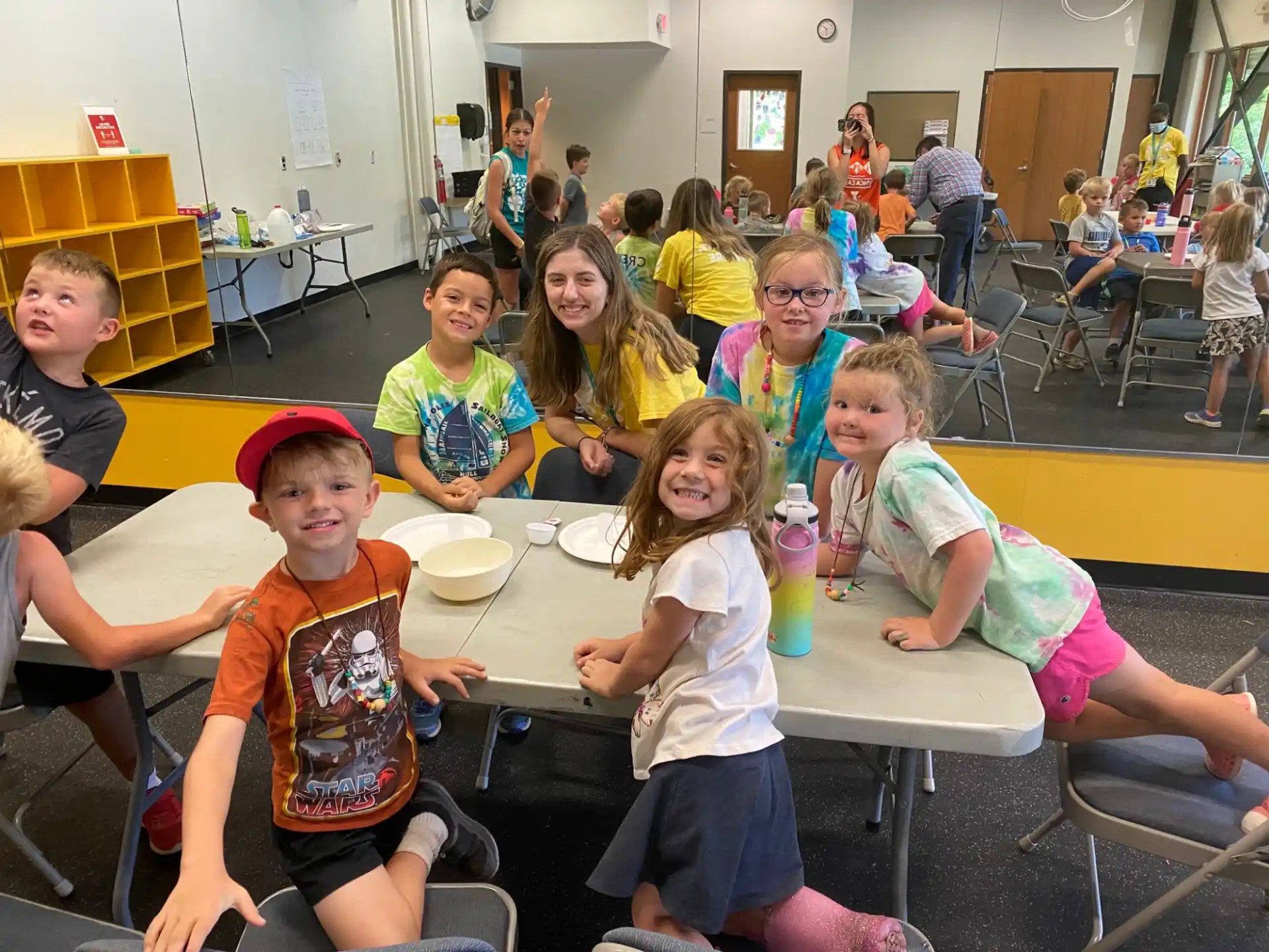 a group of children sitting at a table