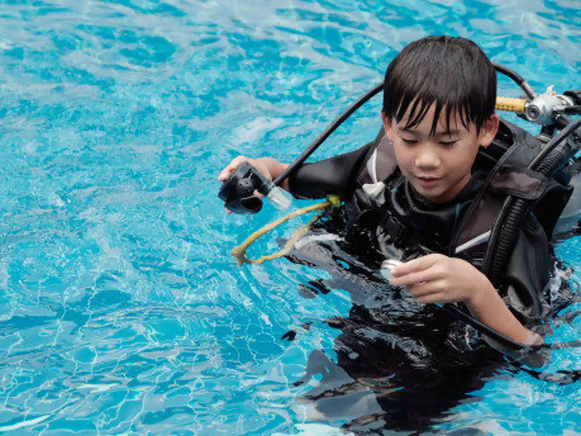 a boy in scuba gear in the water
