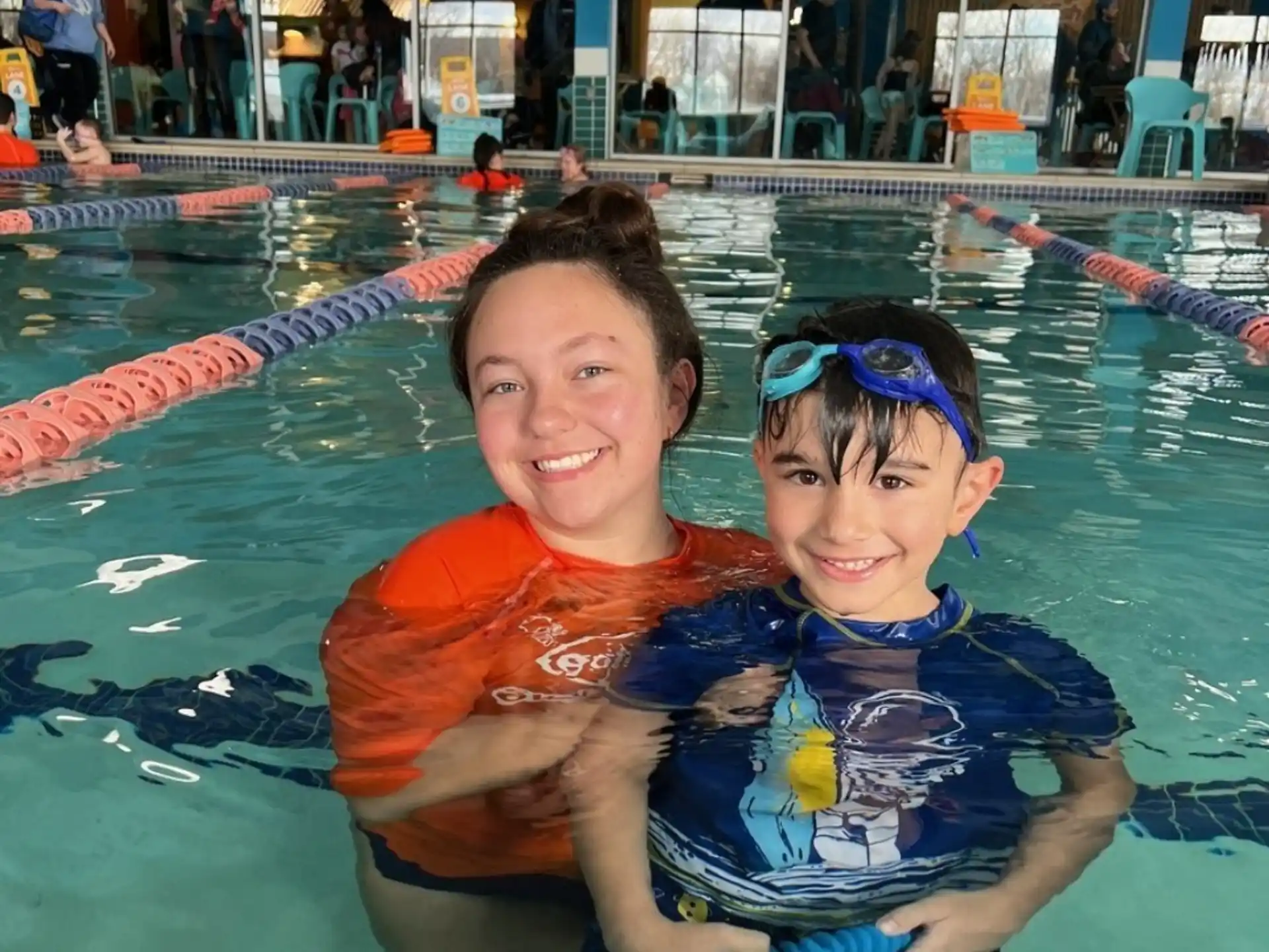 a person and a boy in a pool
