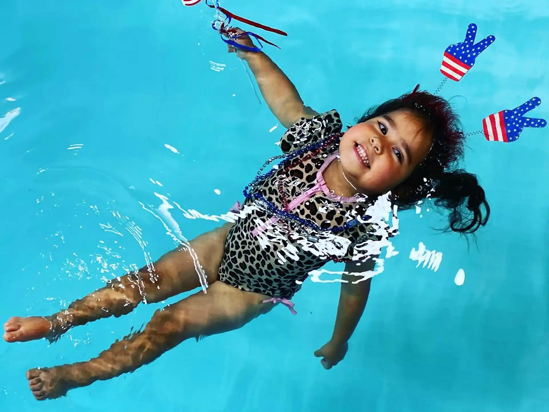 a person in a swimsuit jumping into the water