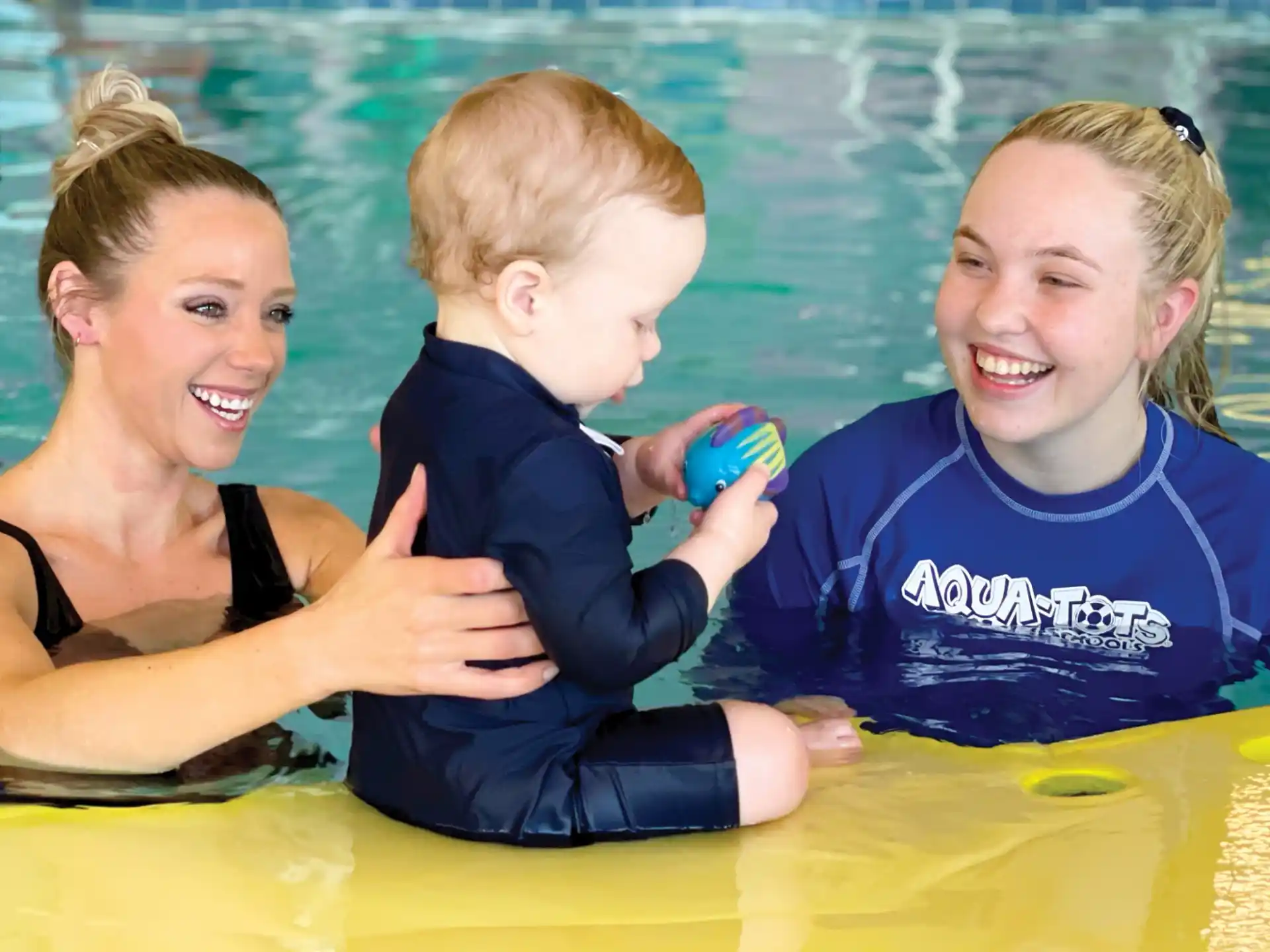 a person and two children in a pool