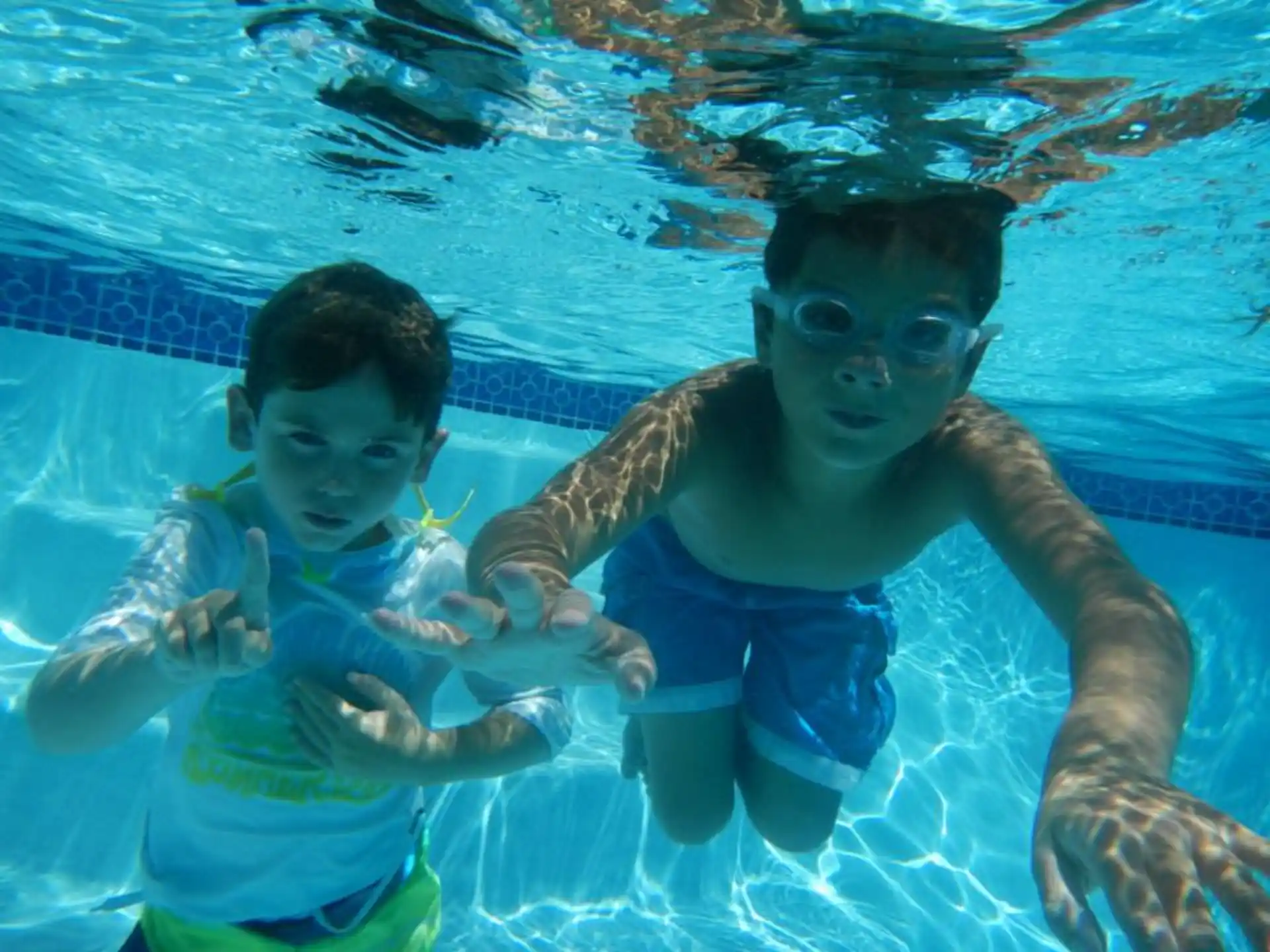 a couple of boys in a pool