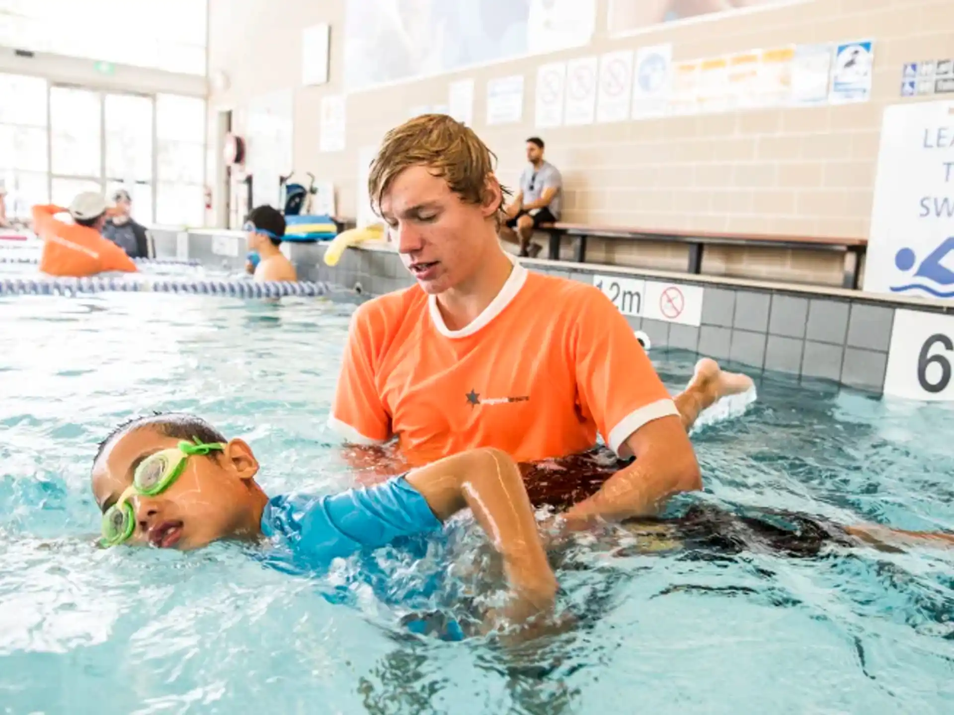 a person and a boy in a pool