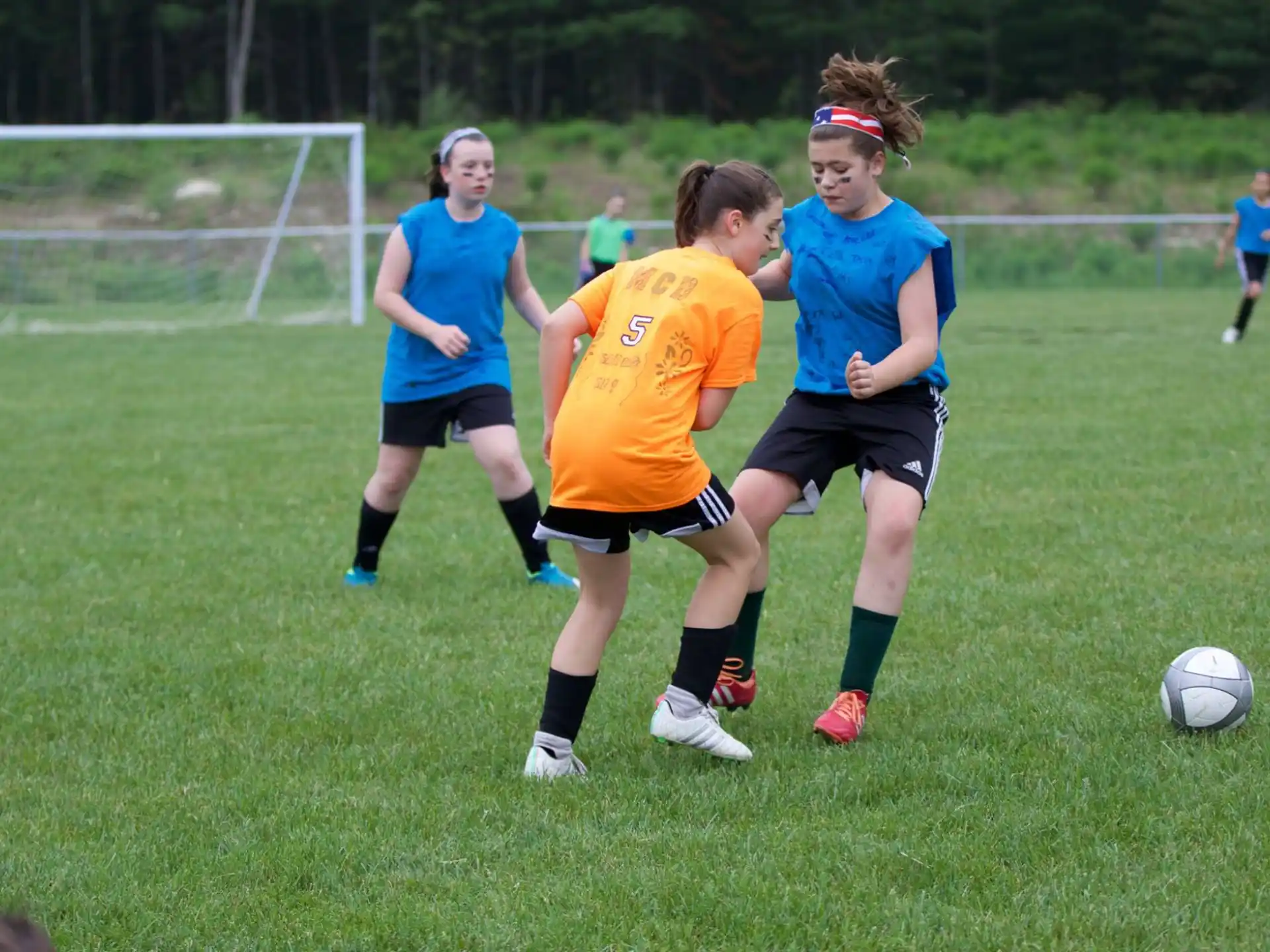 girls playing football on a field