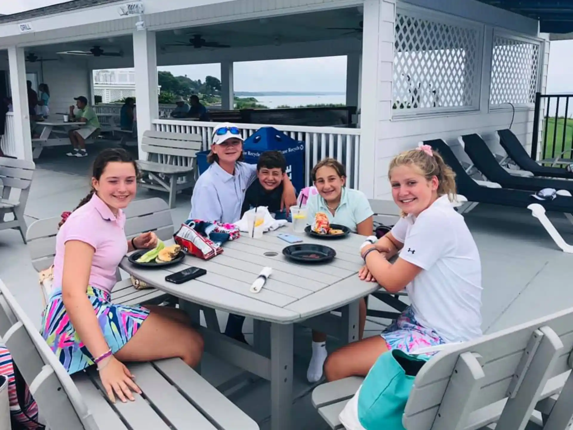 a group of people sitting at a table eating food