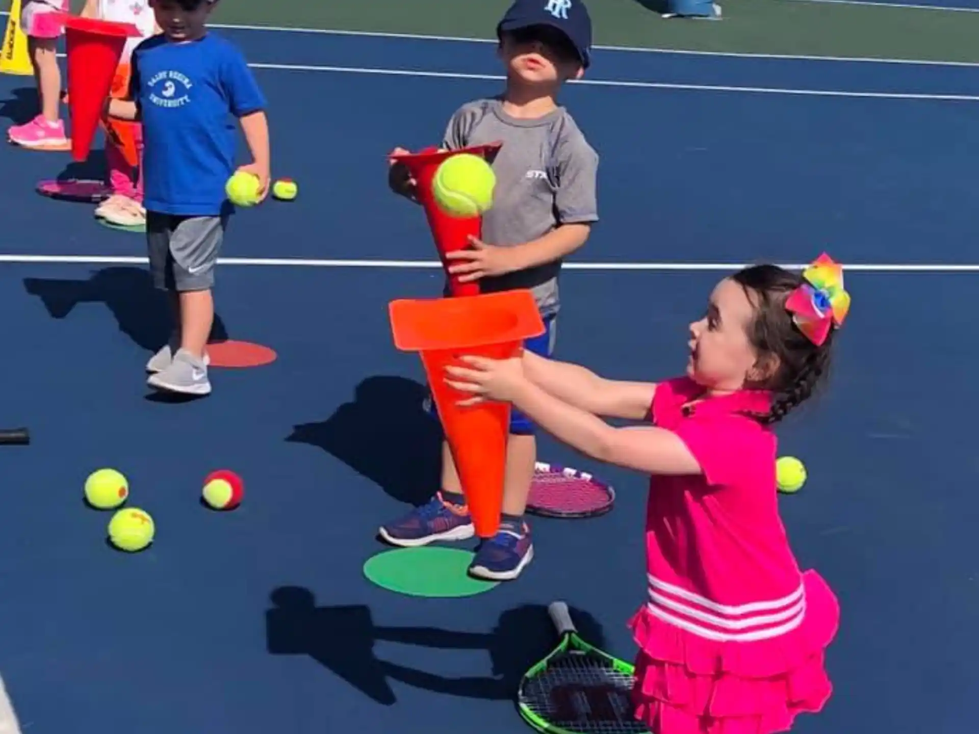 kids playing tennis on a court