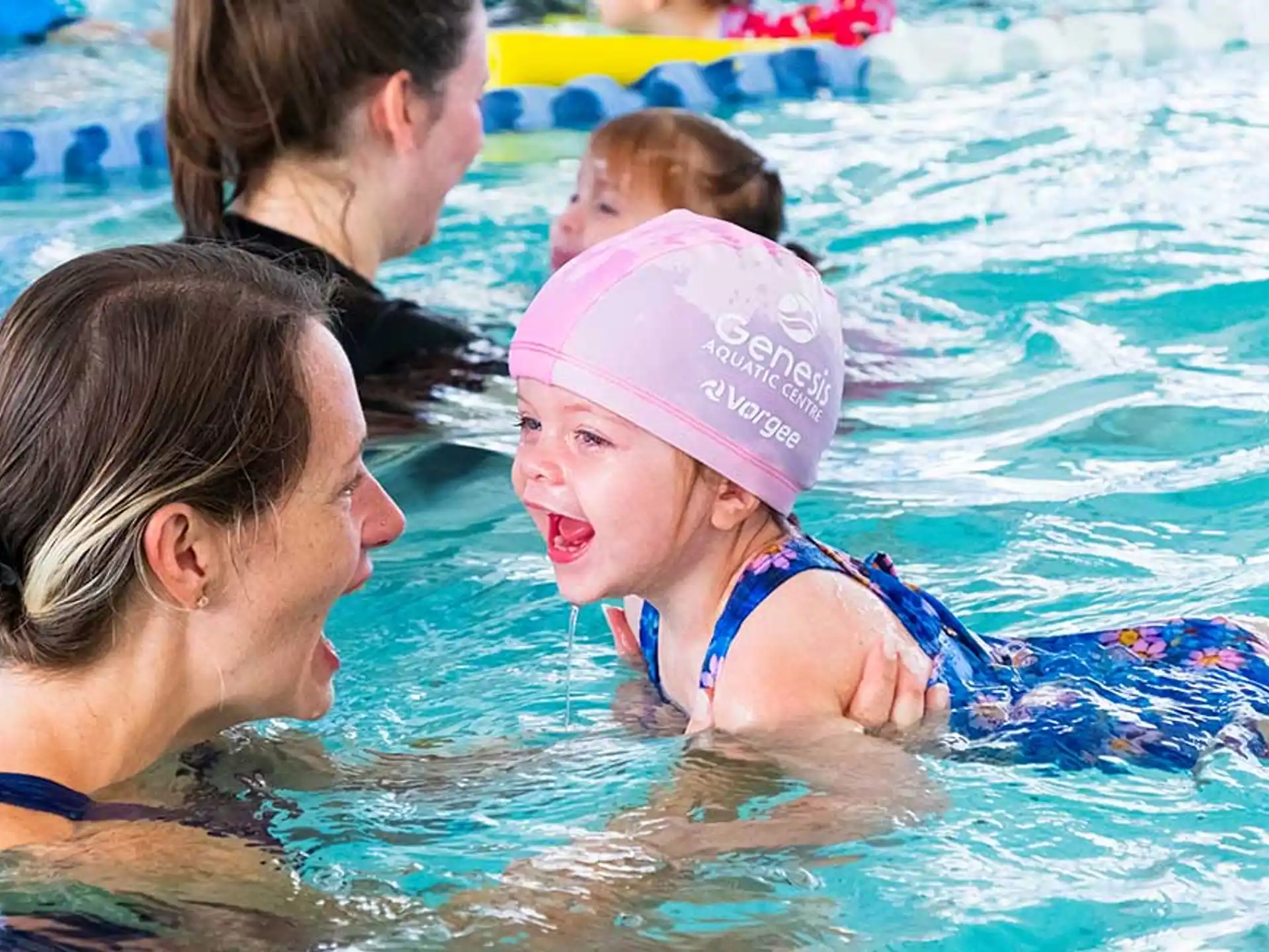 a person and a baby in a pool