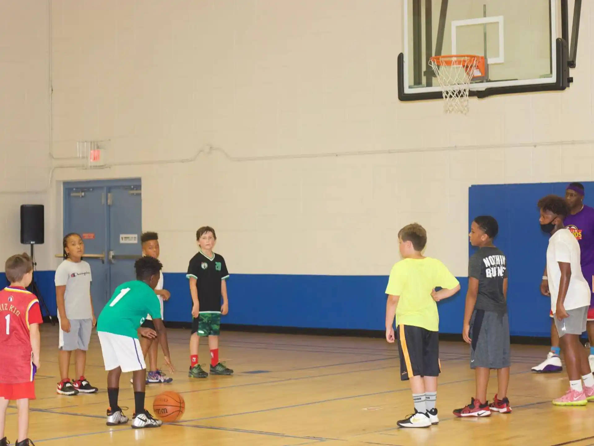 a group of kids playing basketball