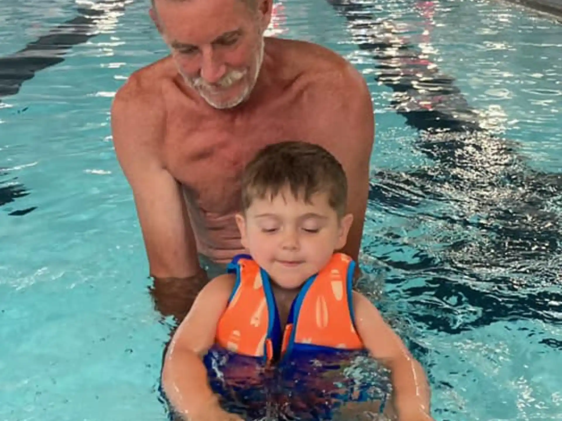 a person and a boy in a pool
