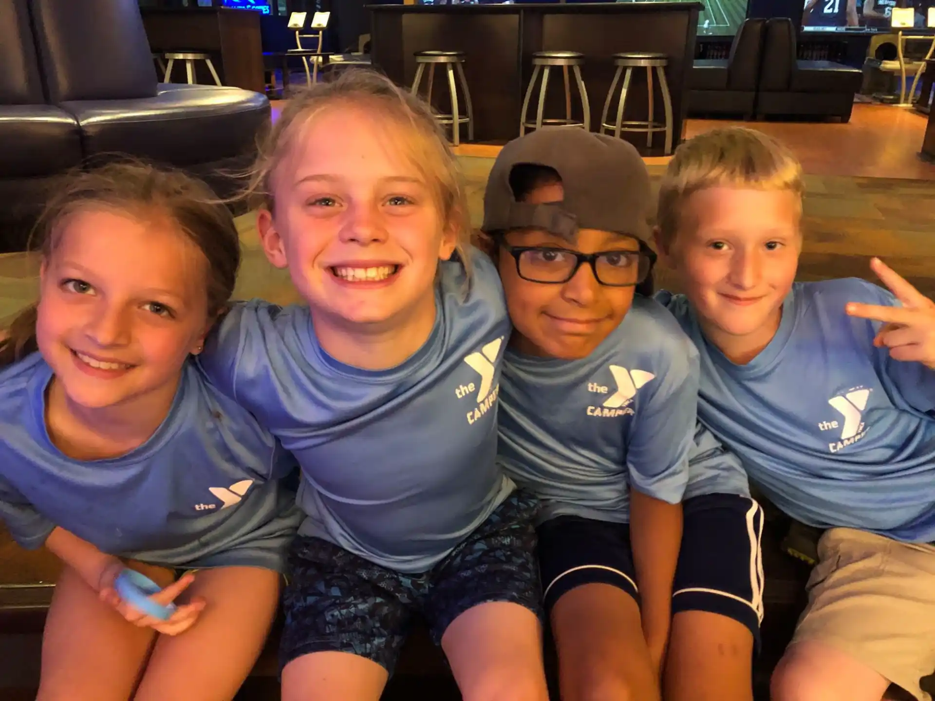 a group of children sitting together smiling