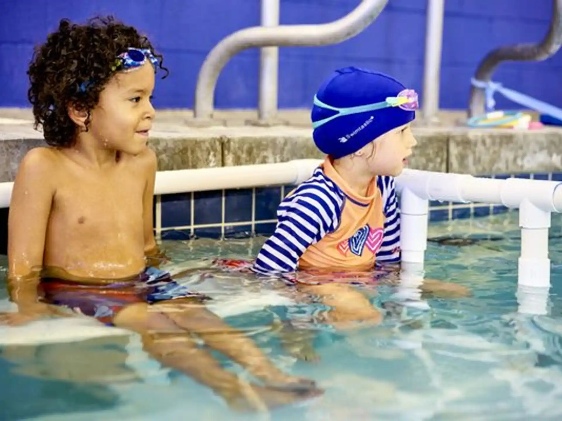 a couple of children in a pool