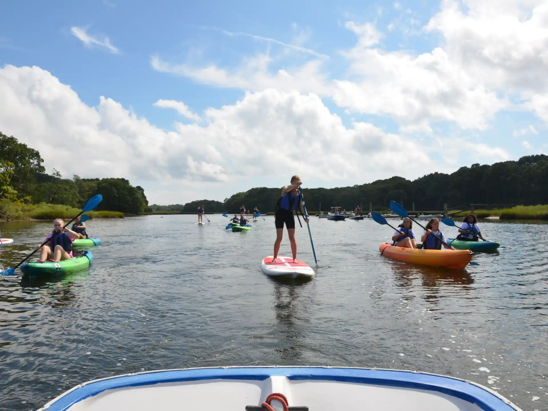 a group of people in kayaks on a lake