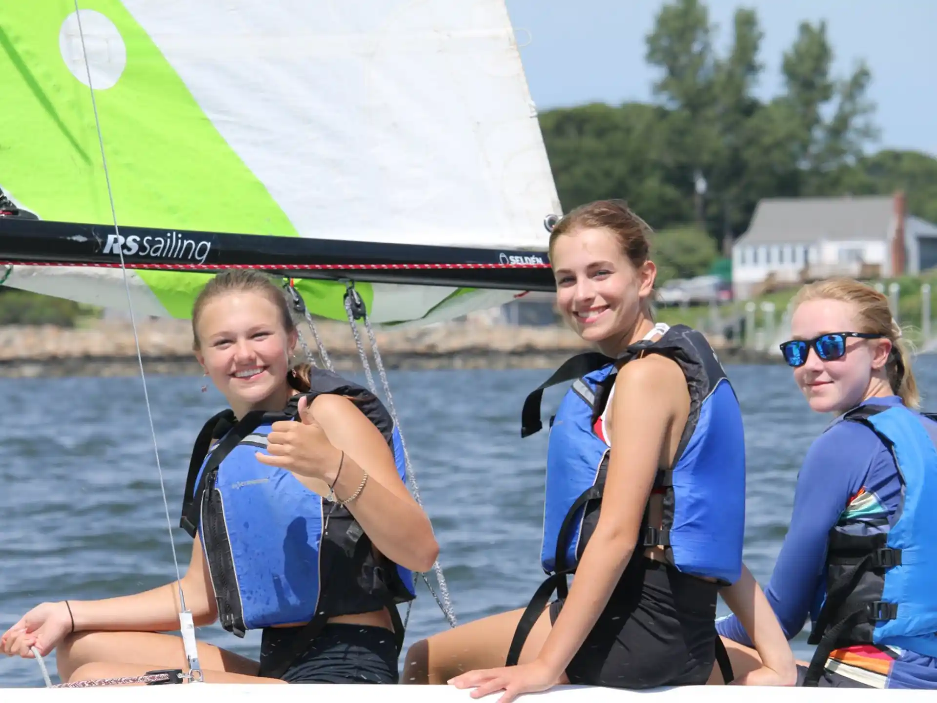 a group of women in life jackets on a boat