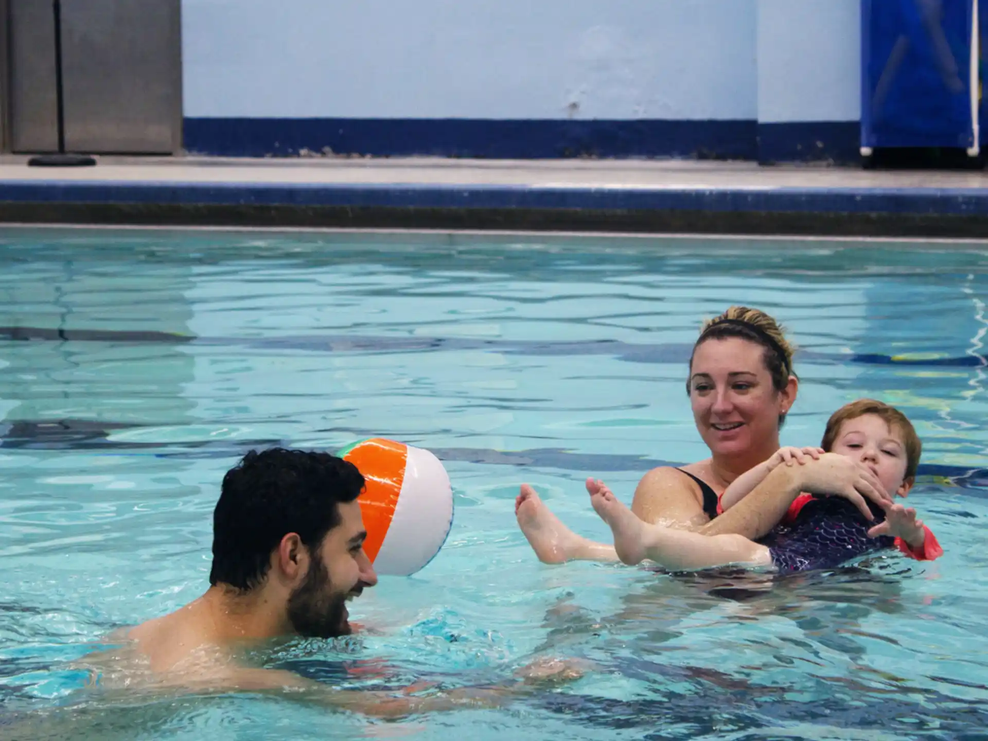 a person and two children in a pool