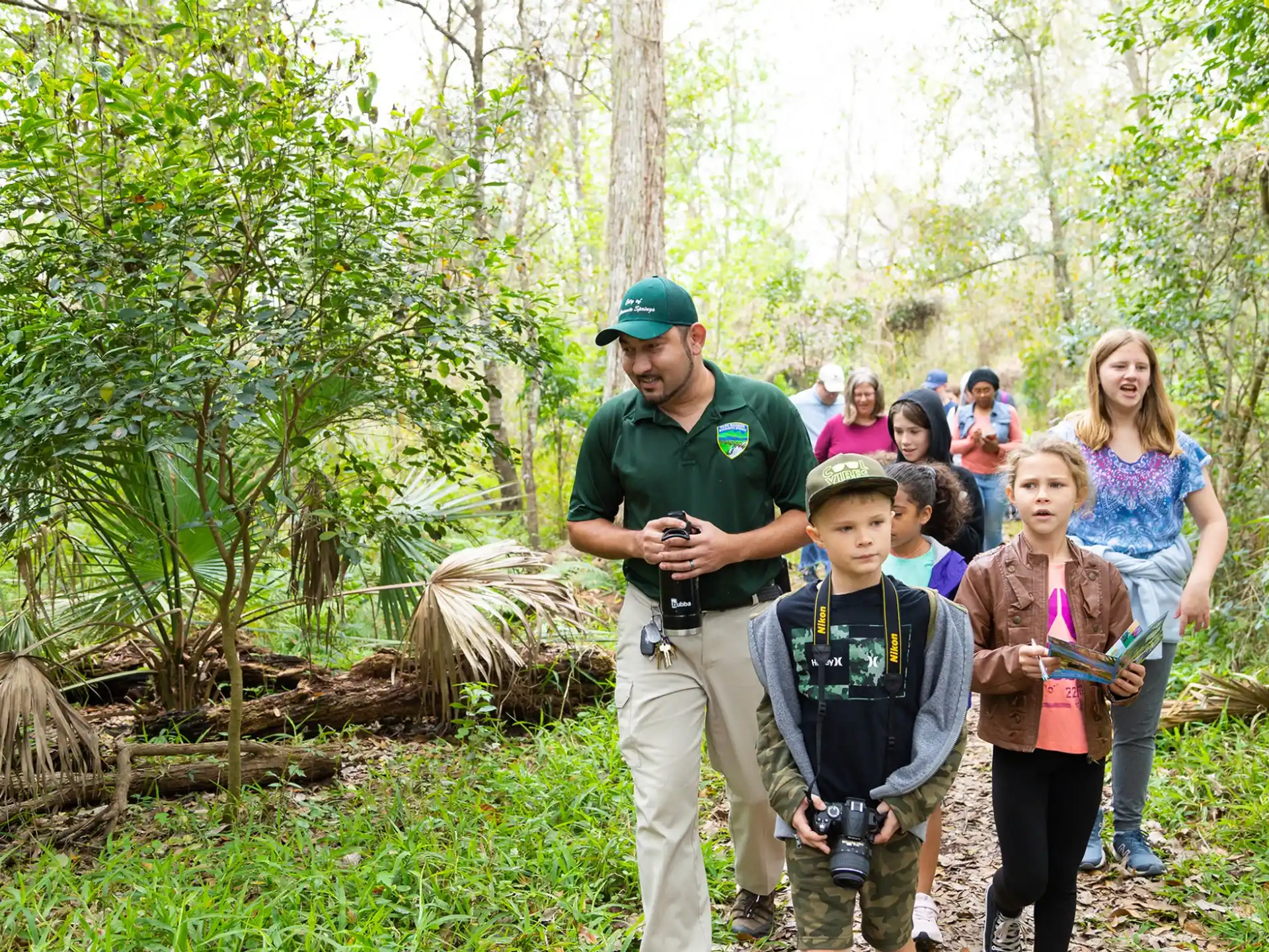 a group of people standing in a forest