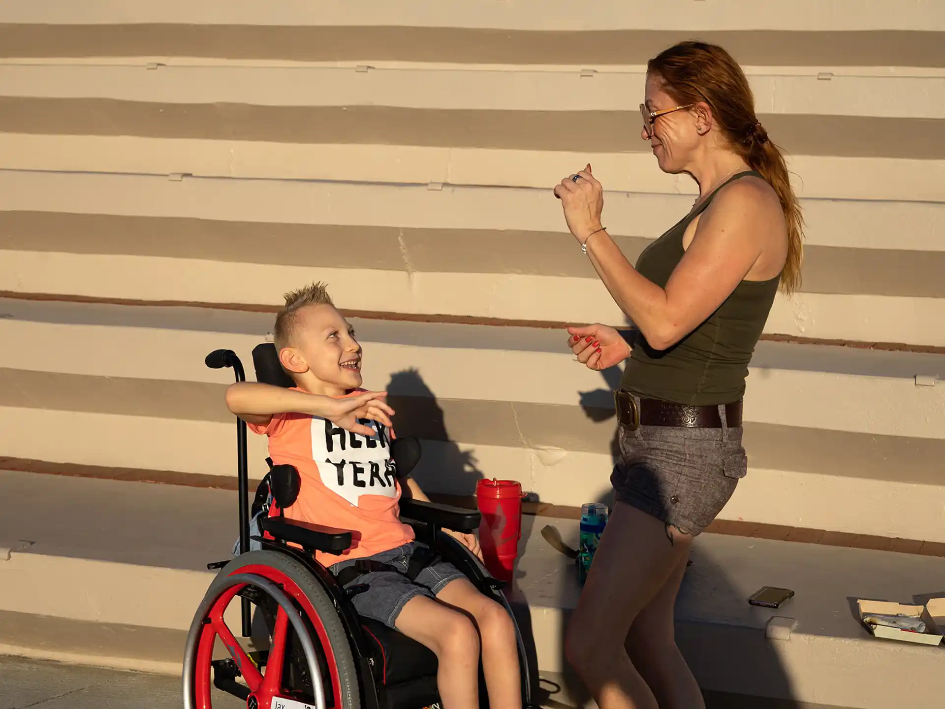 a person and a boy in a wheelchair
