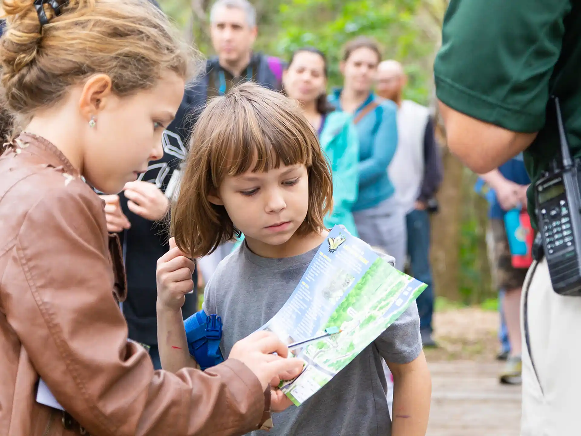 a person reading a book to a young girl