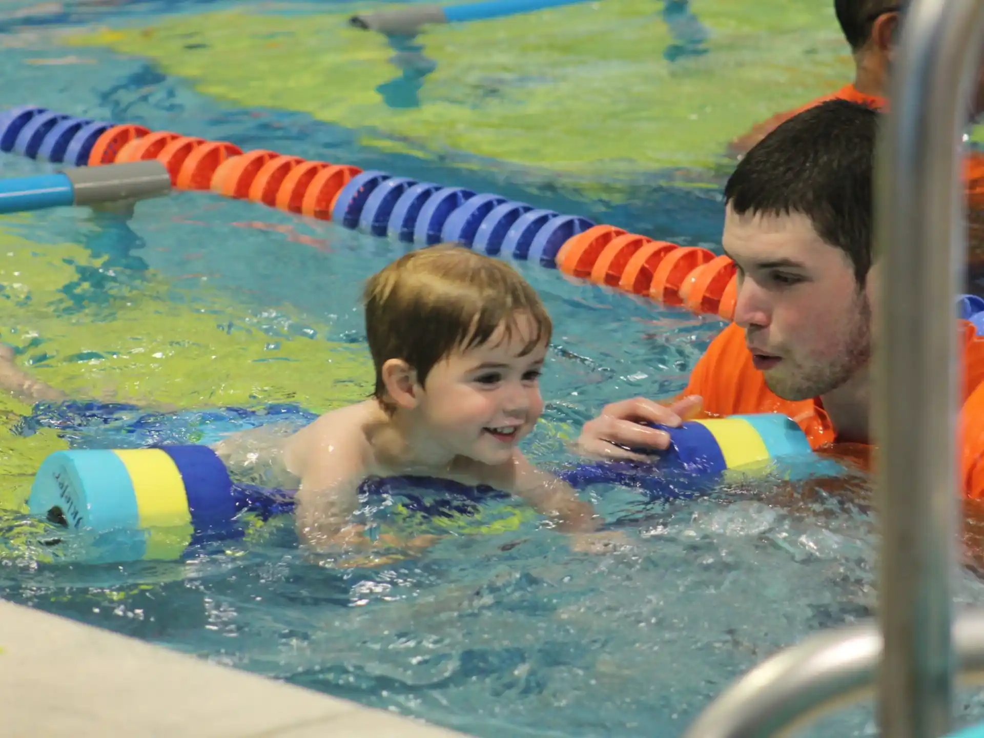 a person and a baby in a pool