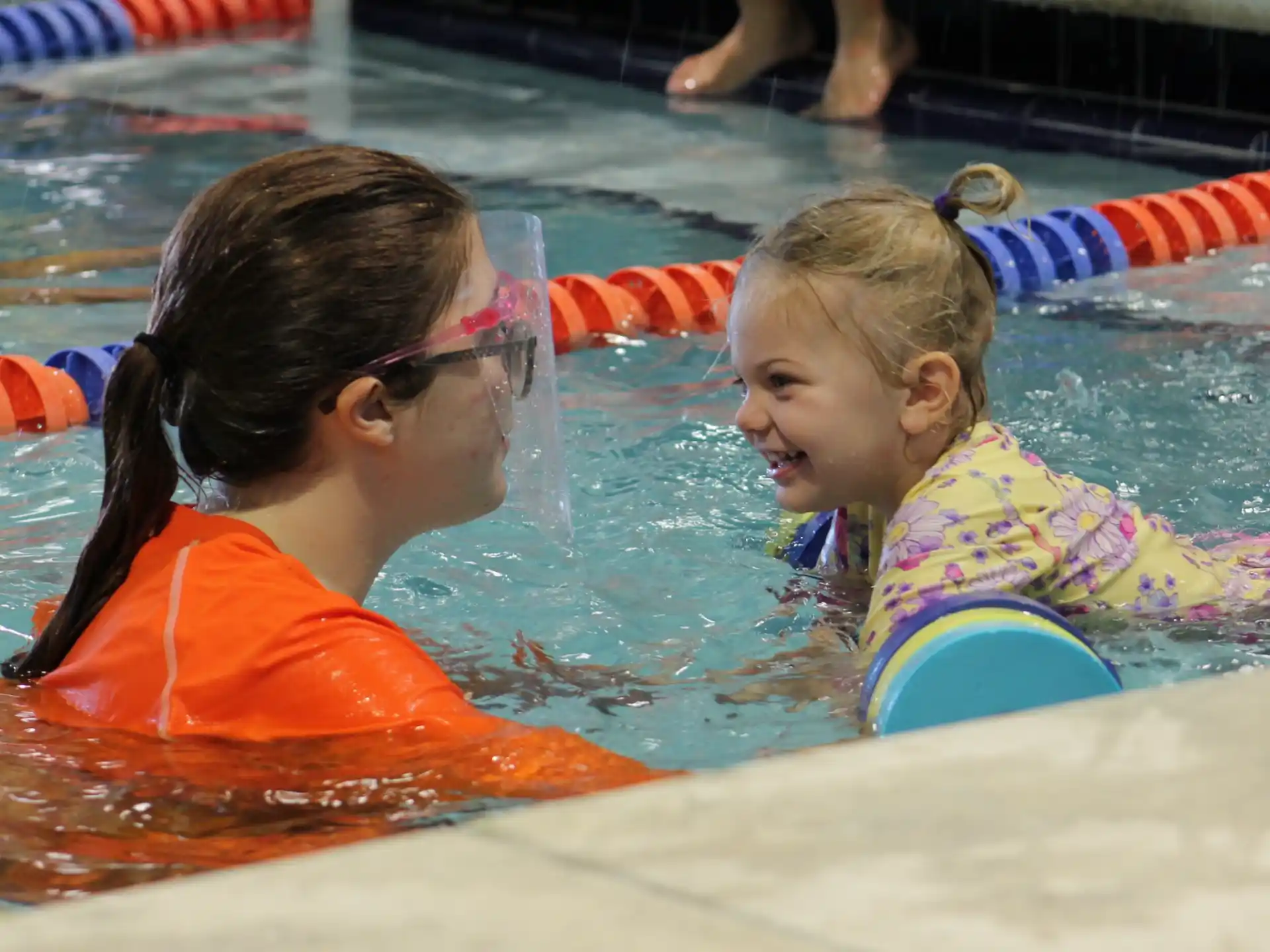a person and a child in a pool