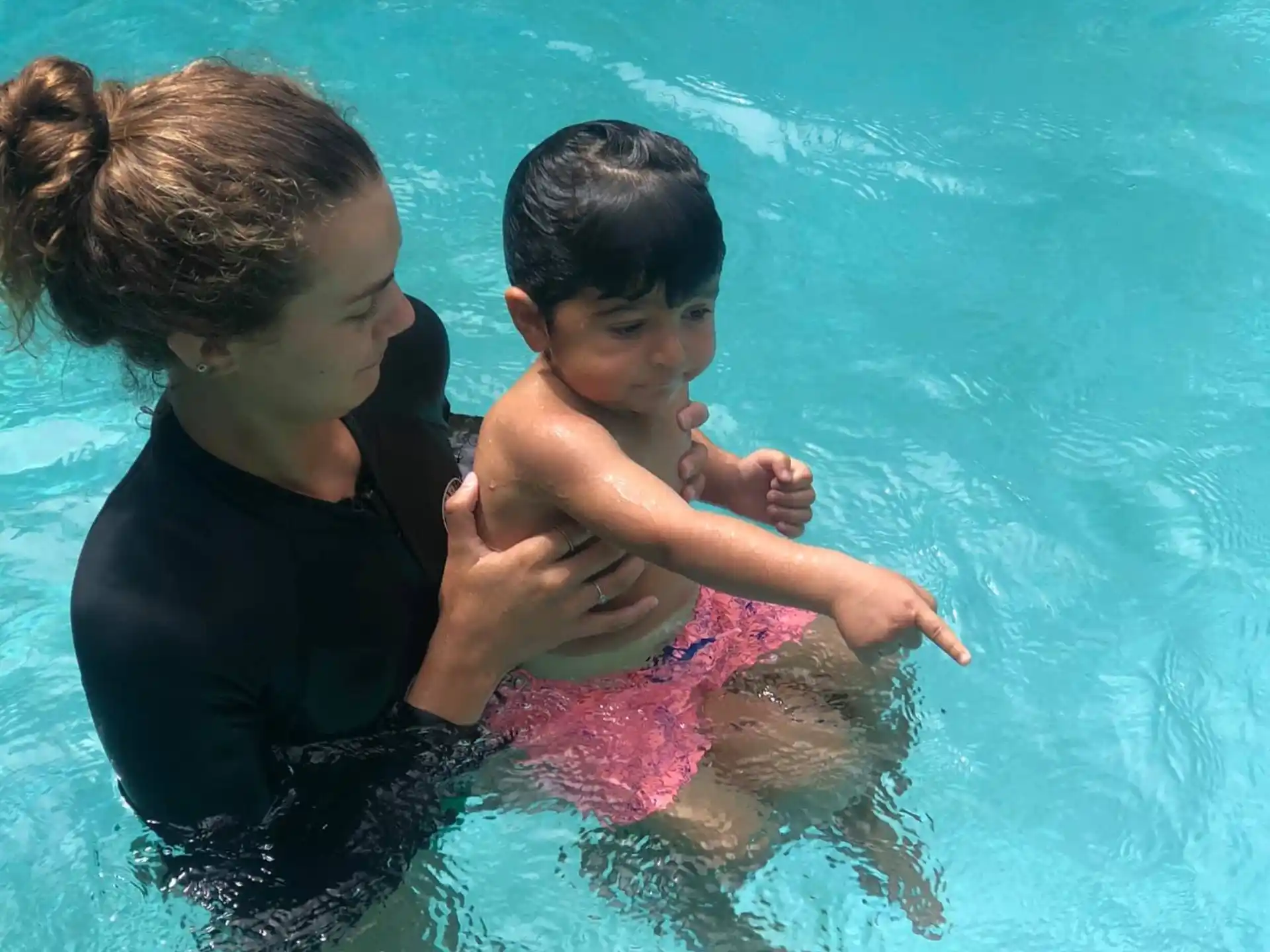 a person and a child in a pool
